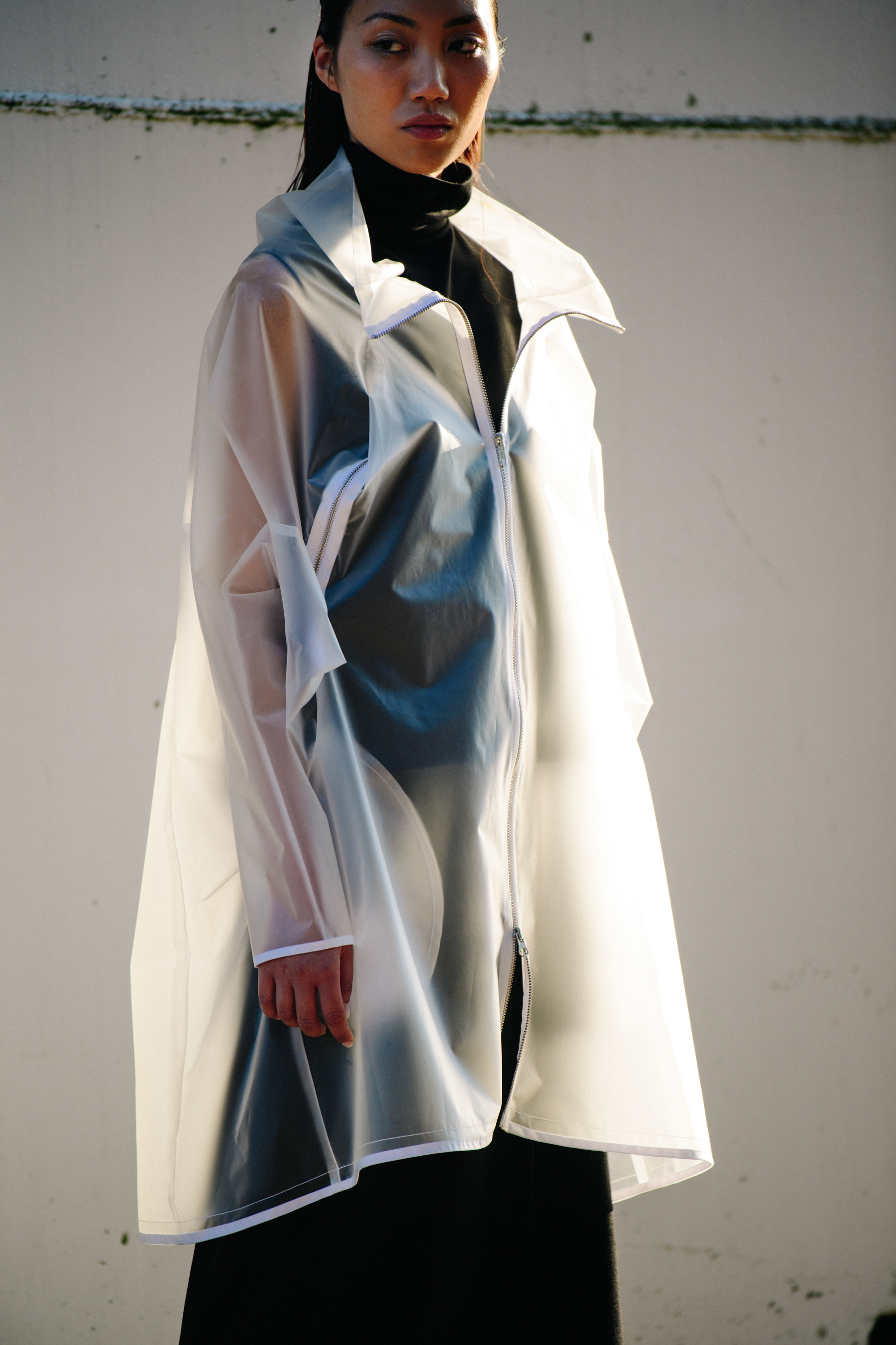 Model wearing plastic coat