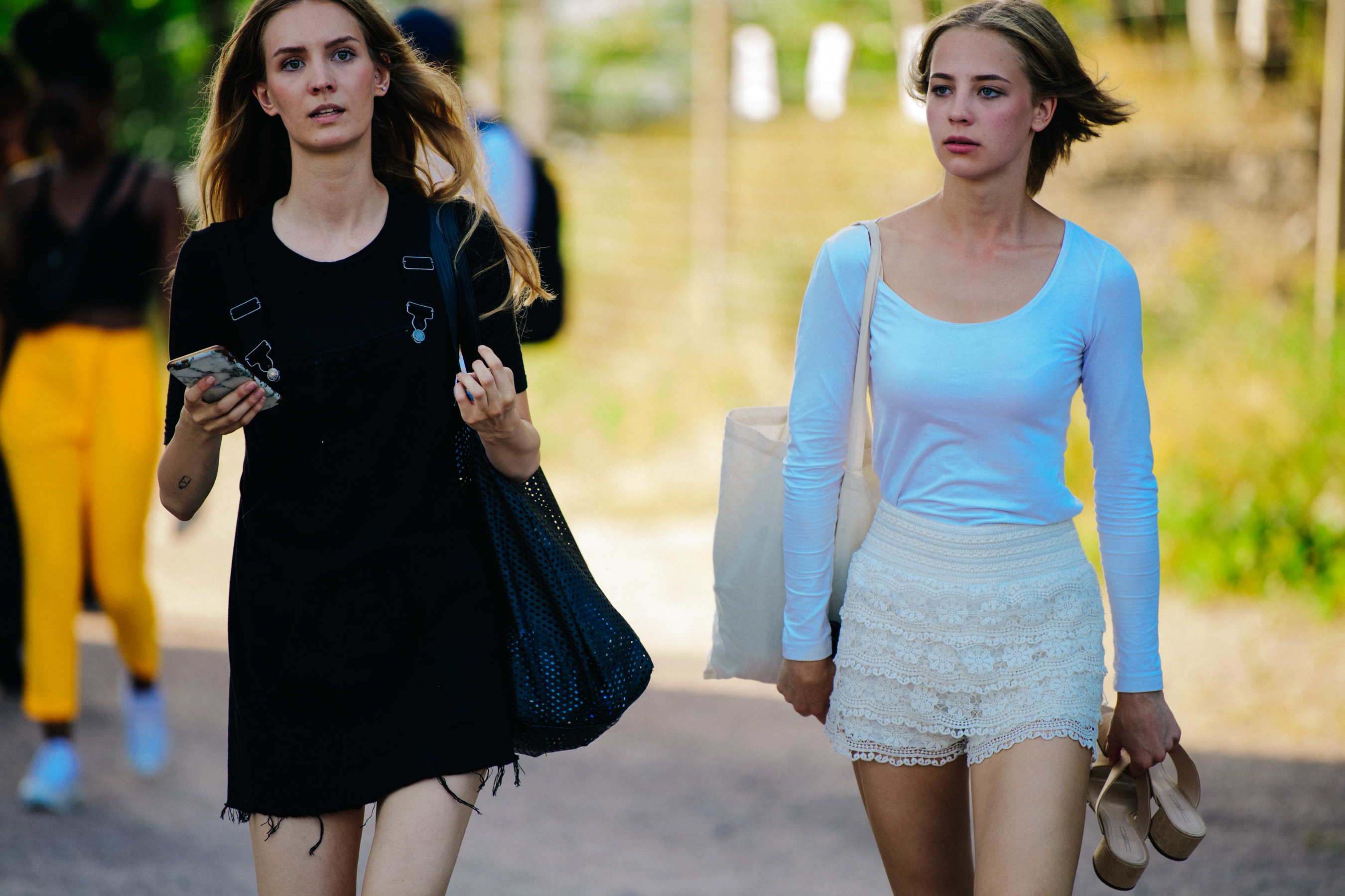 Two models wearing white and black lace
