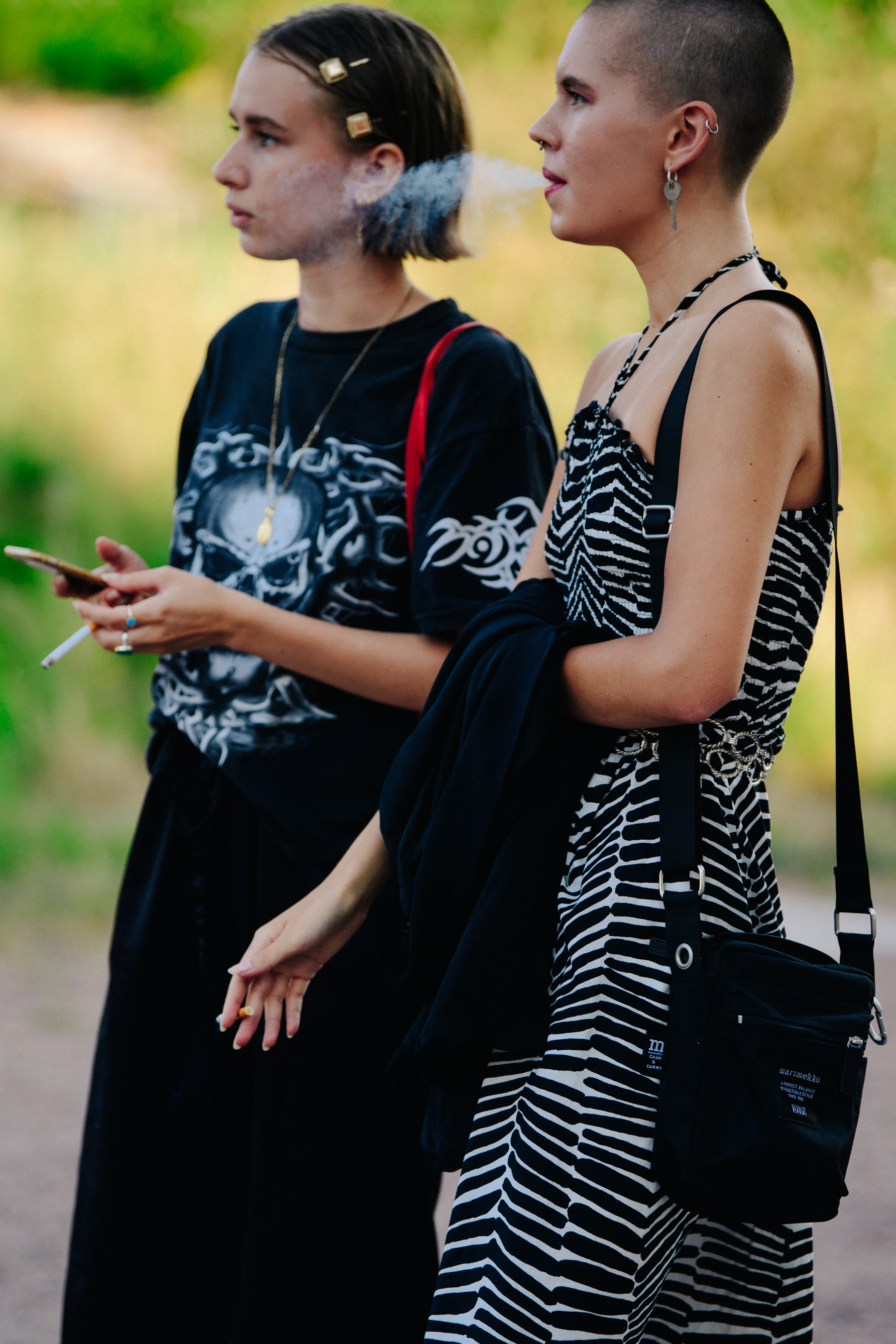 Two models wearing dark outfits