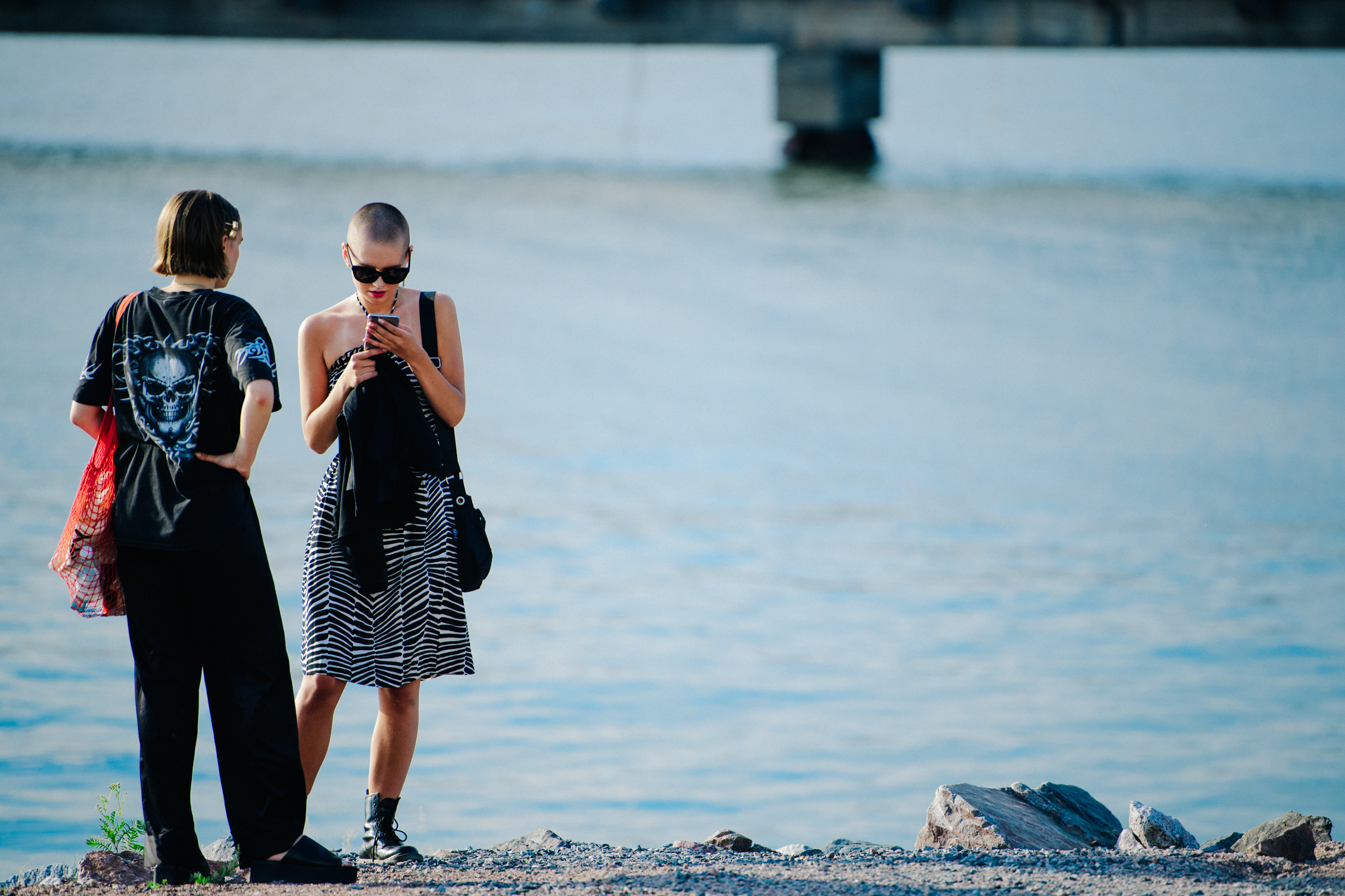 Two models wearing dark outfits