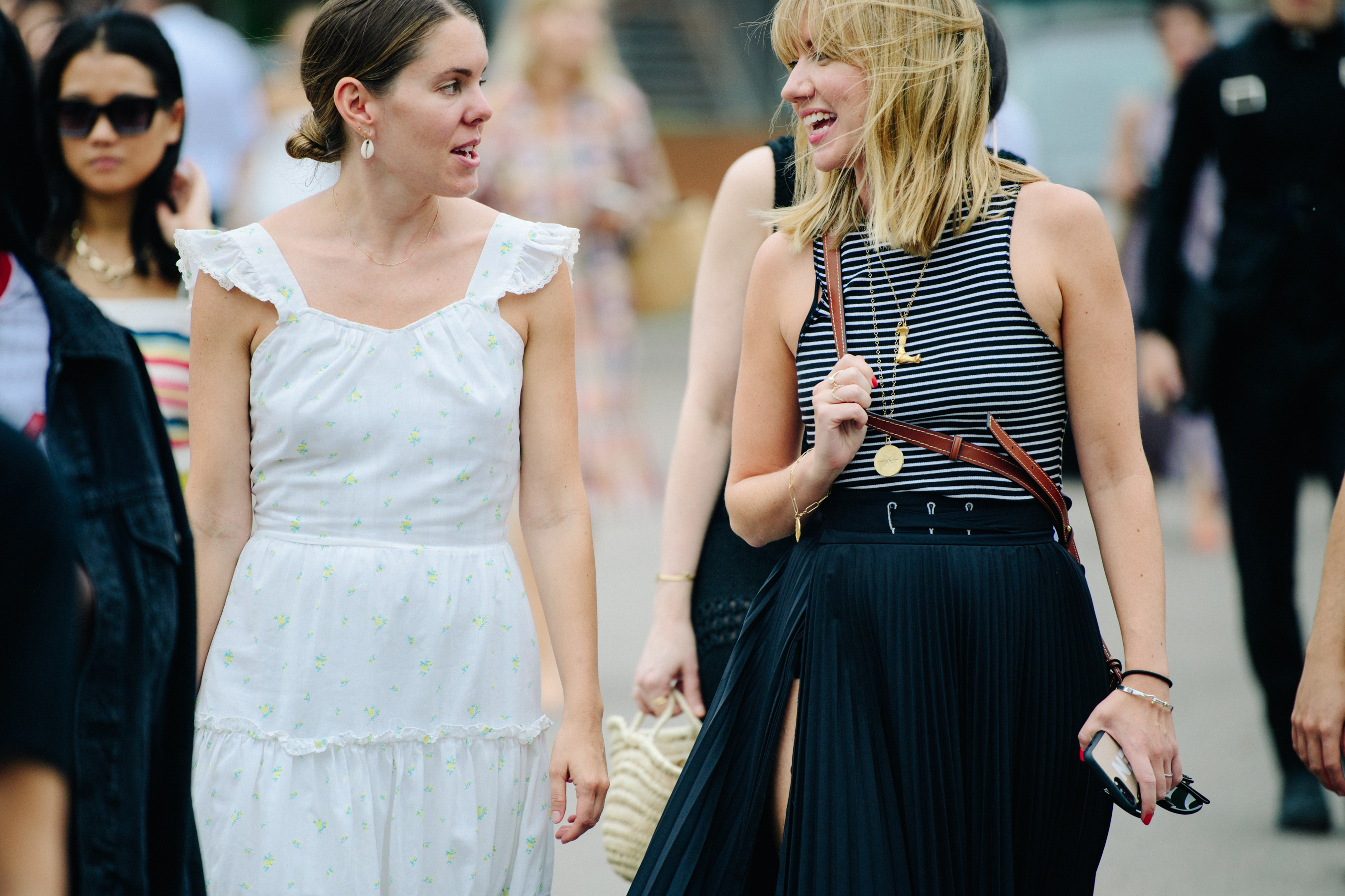 Two women wearing summer clothing
