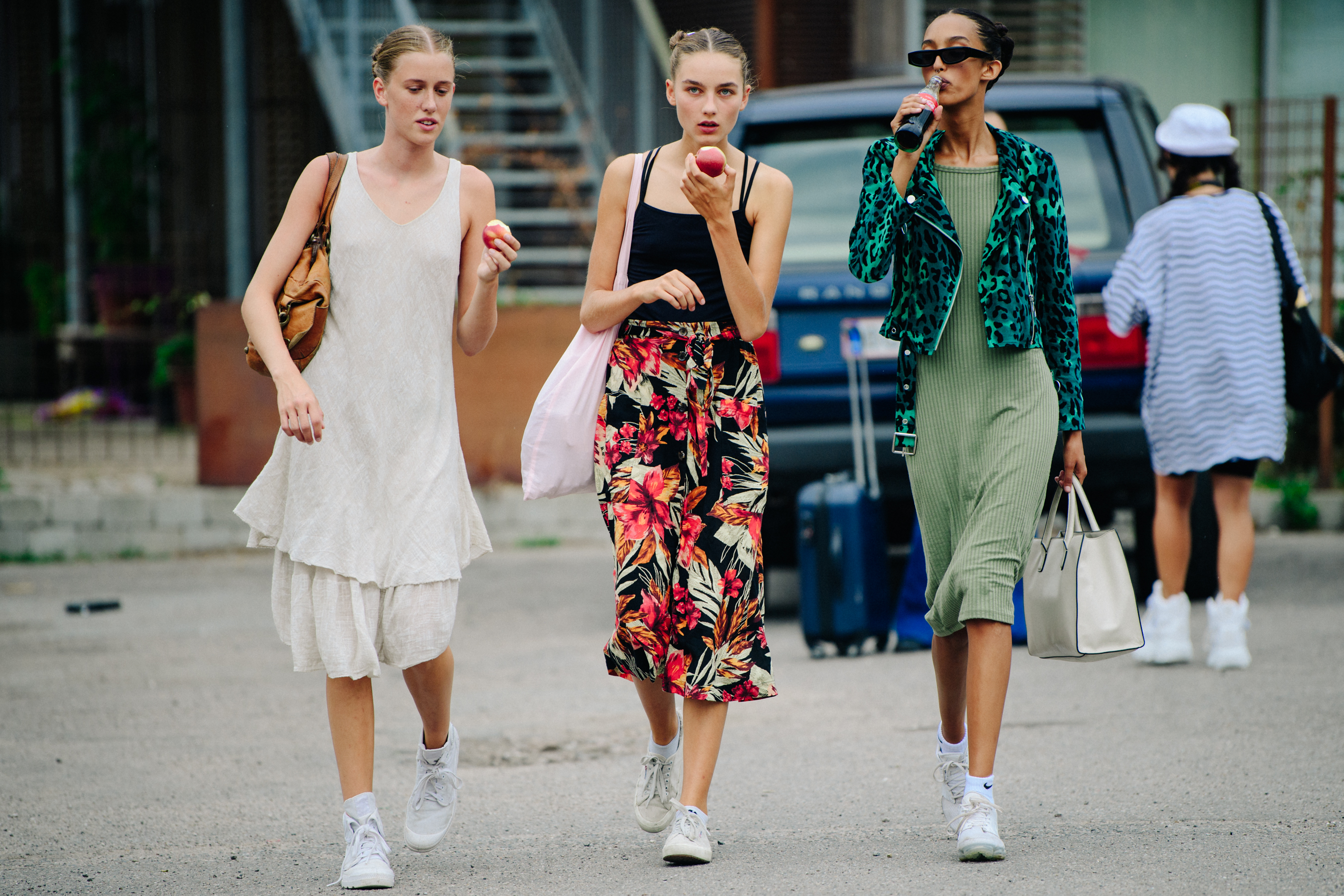 Three models wearing summer dresses