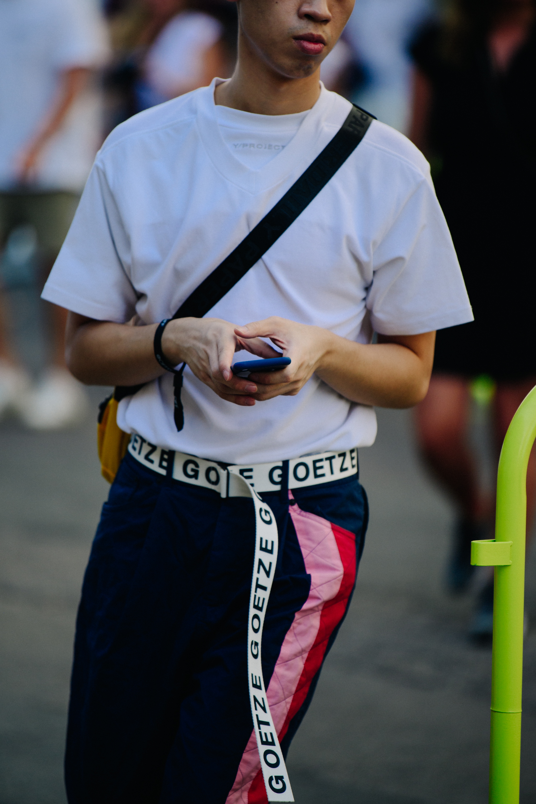 Man wearing long branded belt