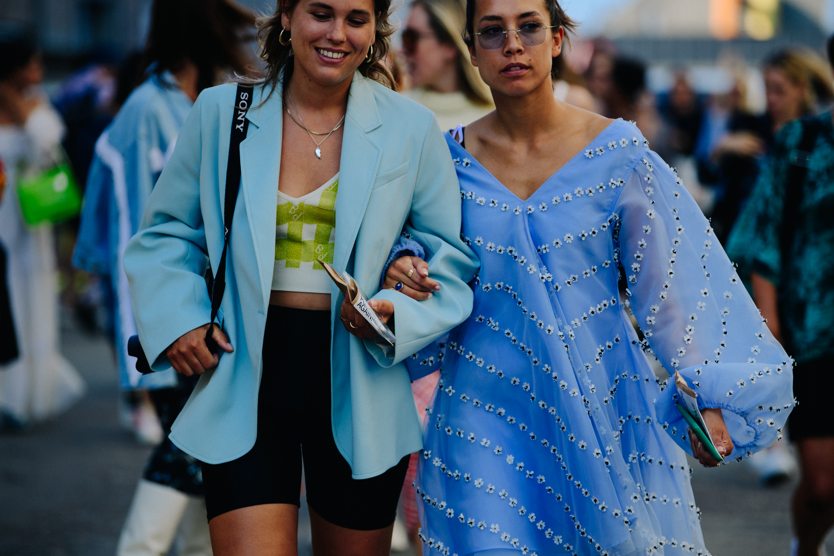 Two women wearing blue