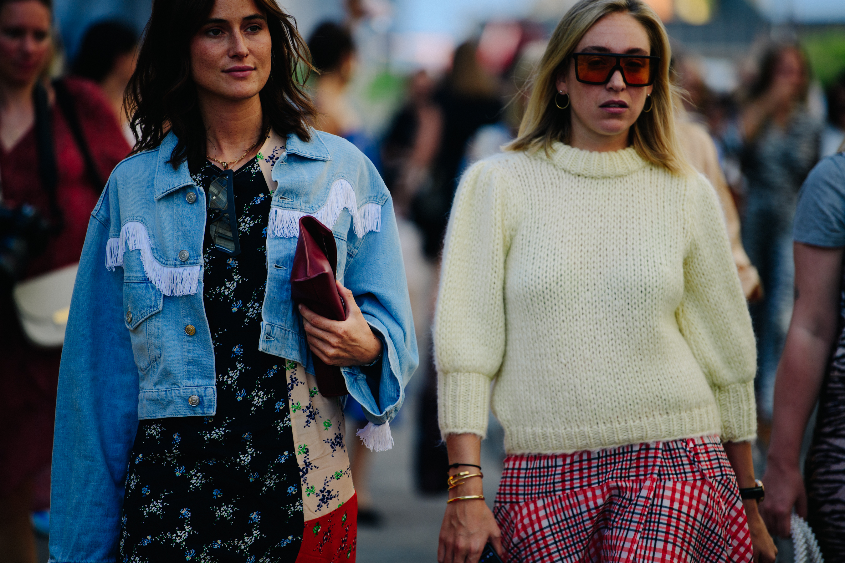Two women wearing pattern dresses