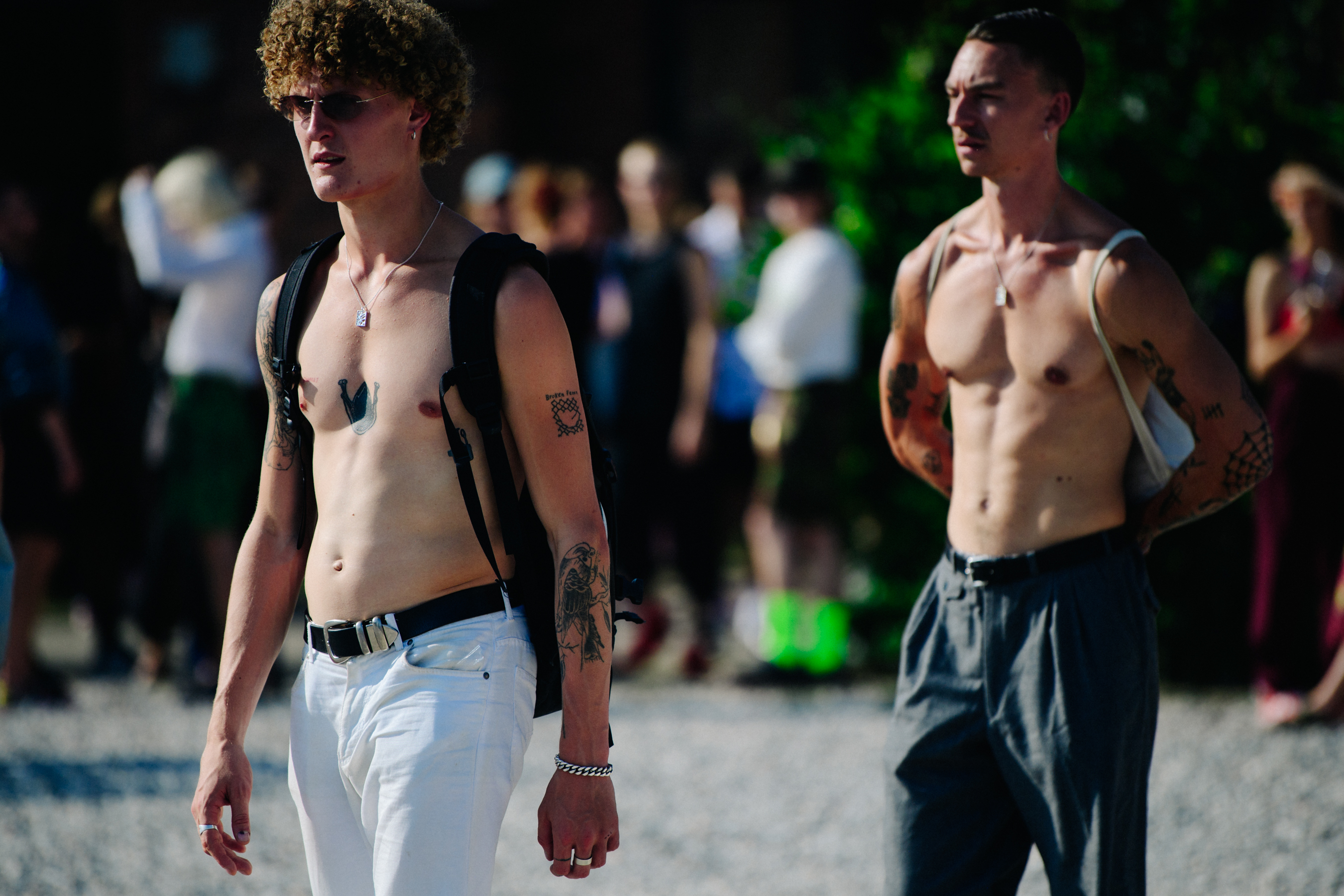 Two topless men with tattoos