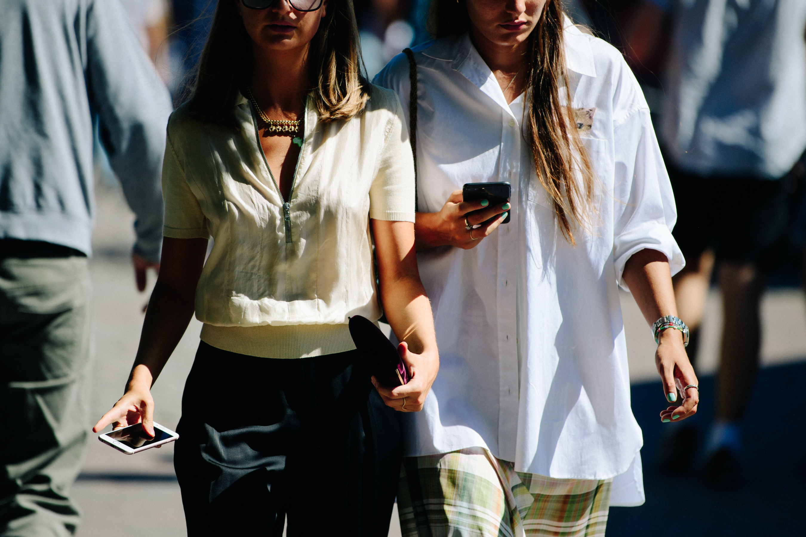 Two women wearing light shirts