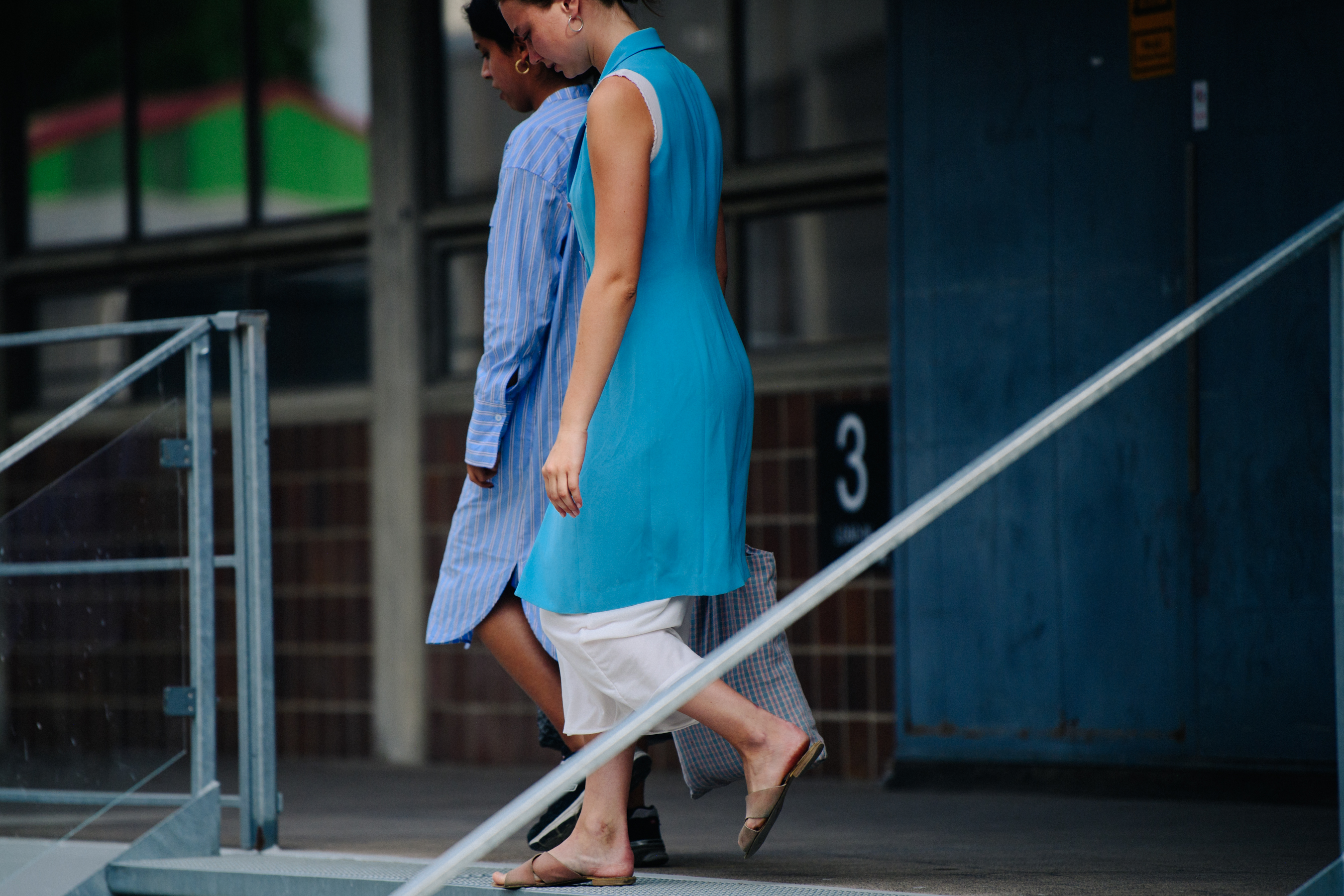 Two women wearing blue outfits