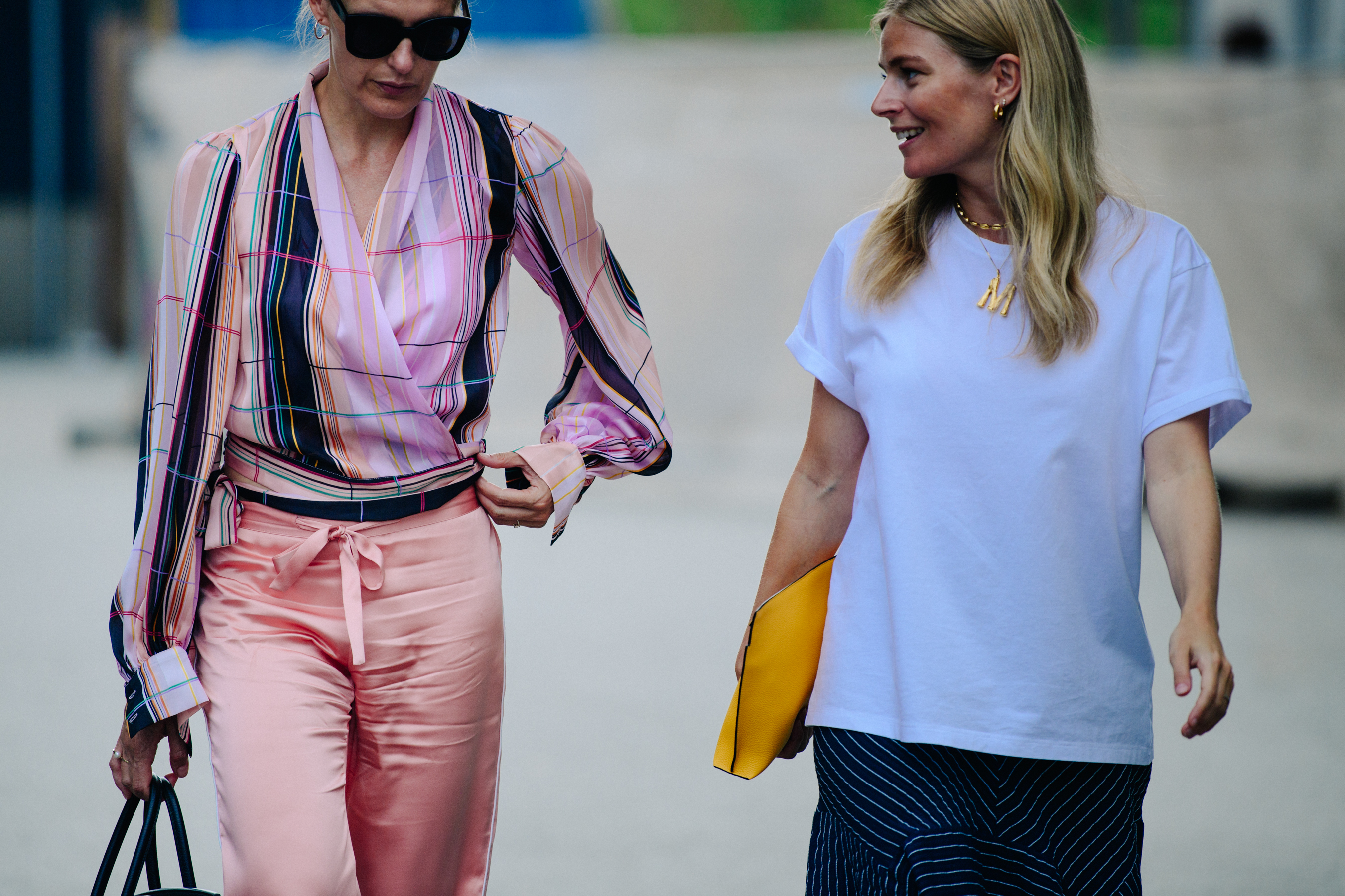 Two women wearing light shirts