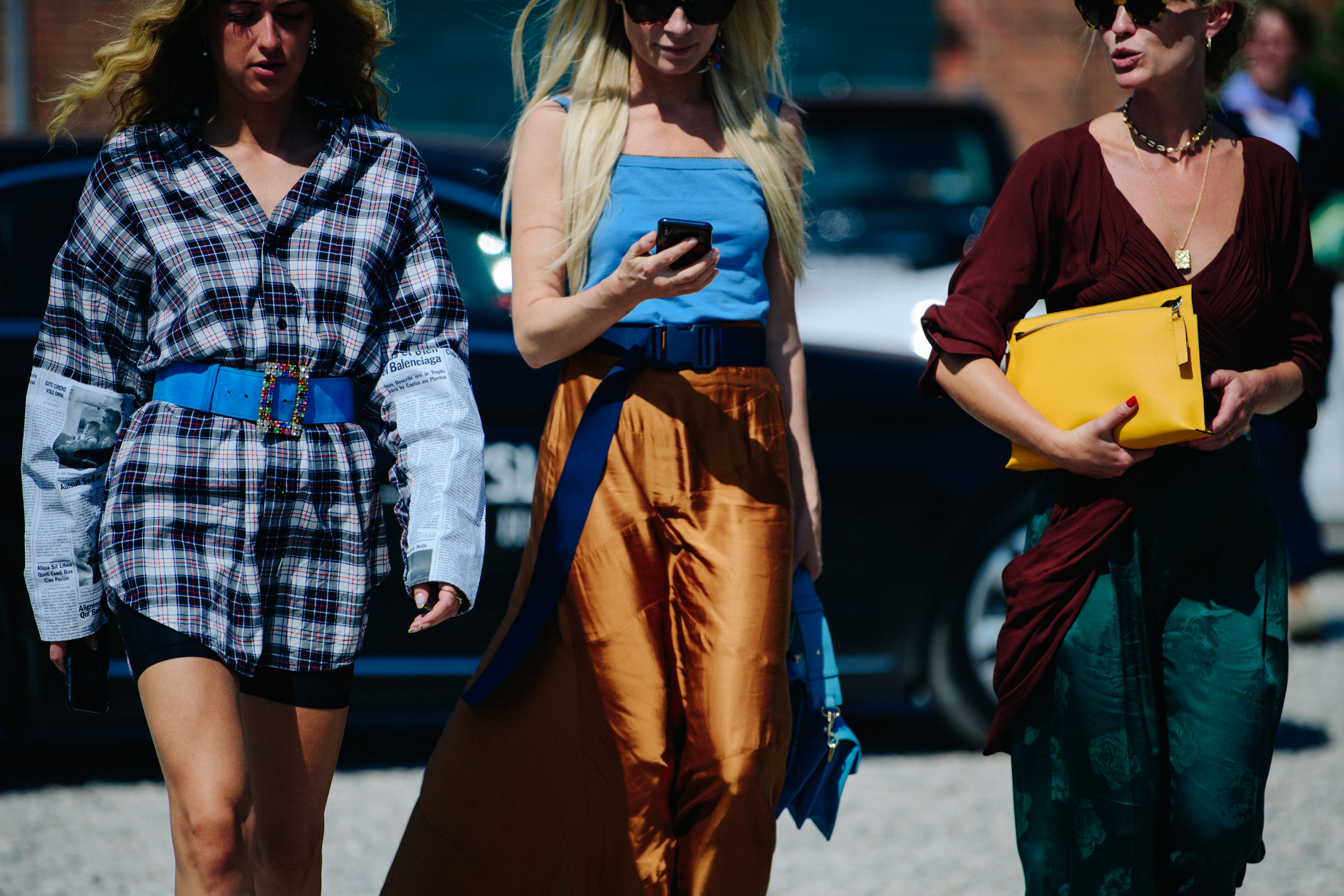 Three women wearing stylish clothing