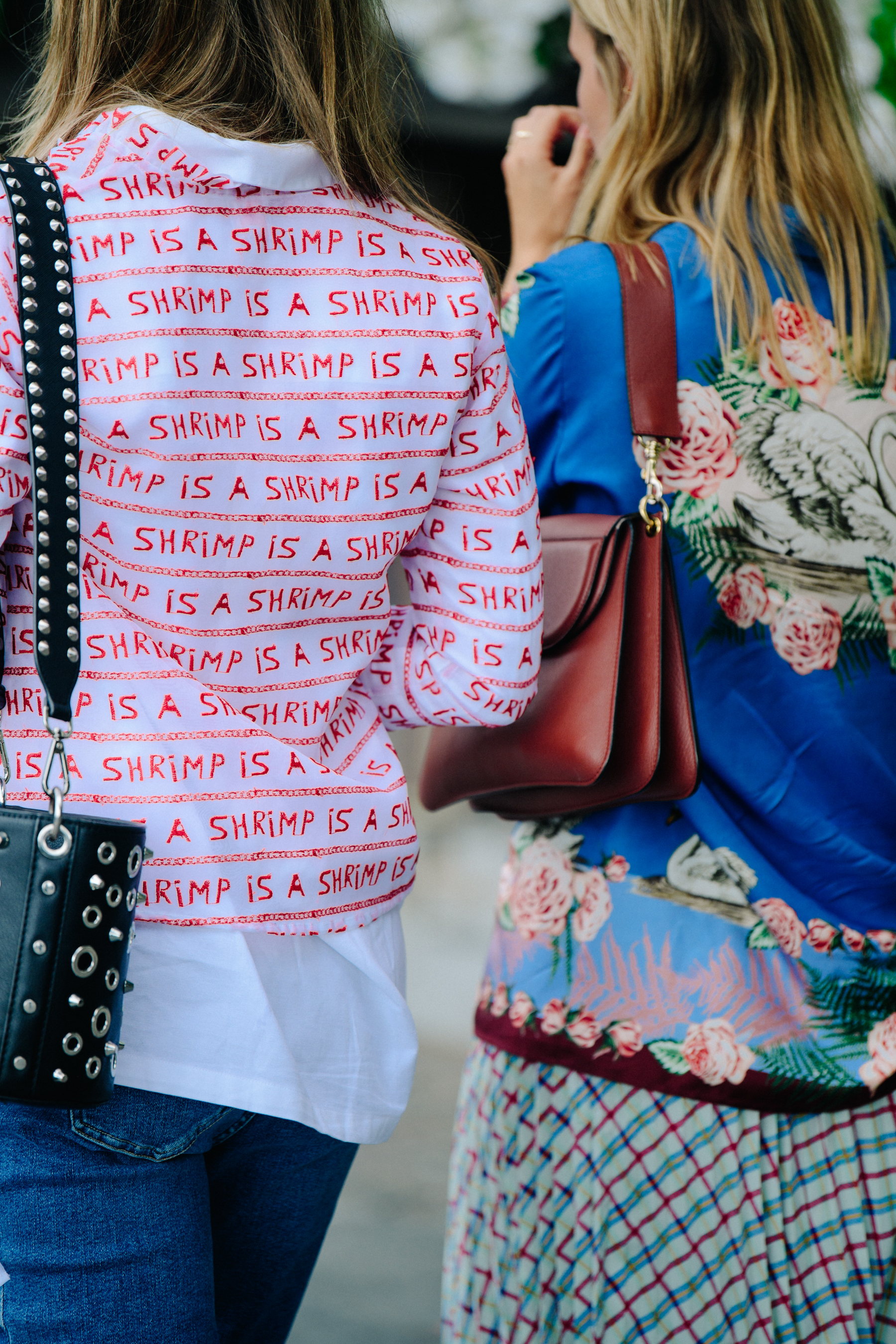 Two women wearing pattern shirts