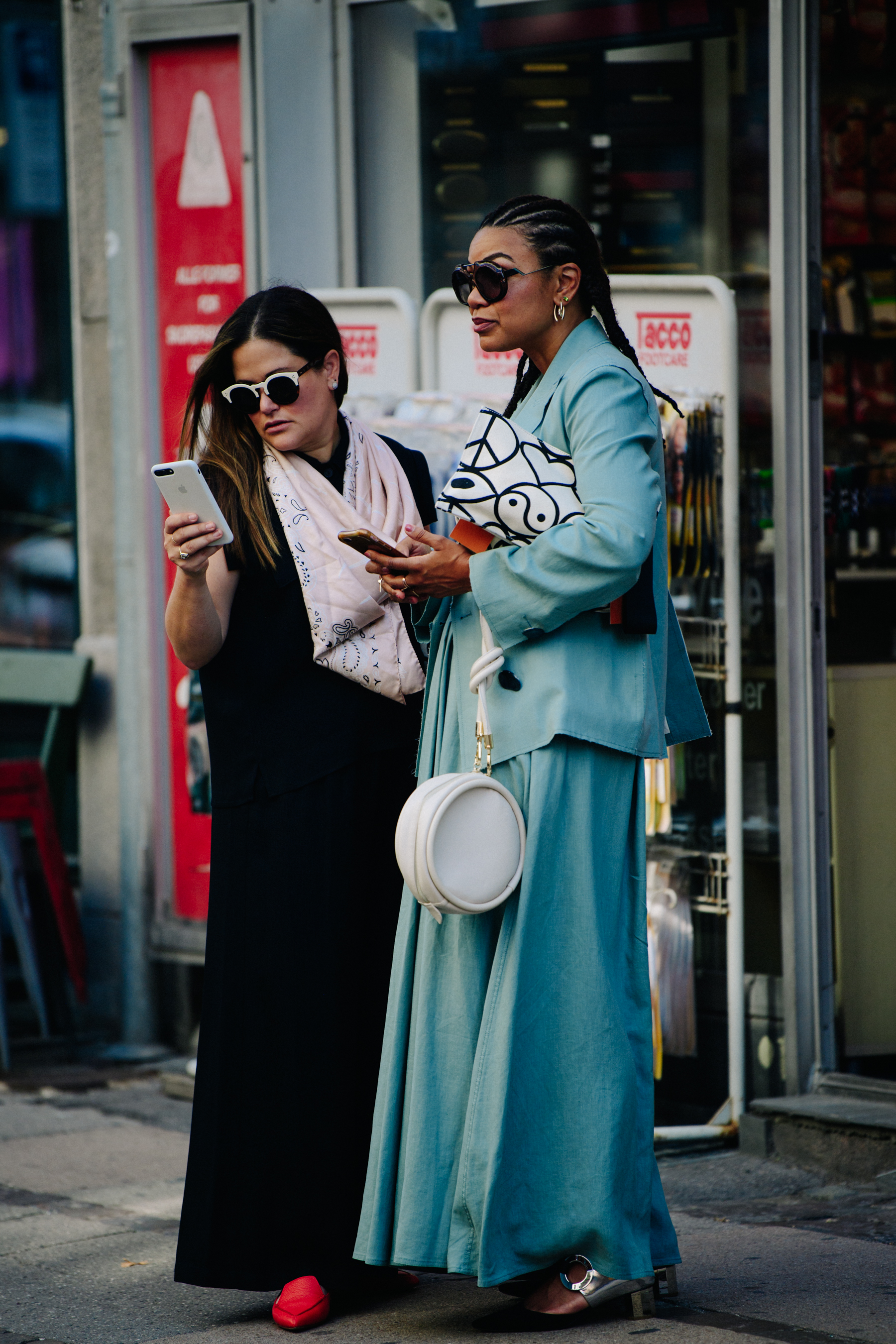 Two women wearing long dresses