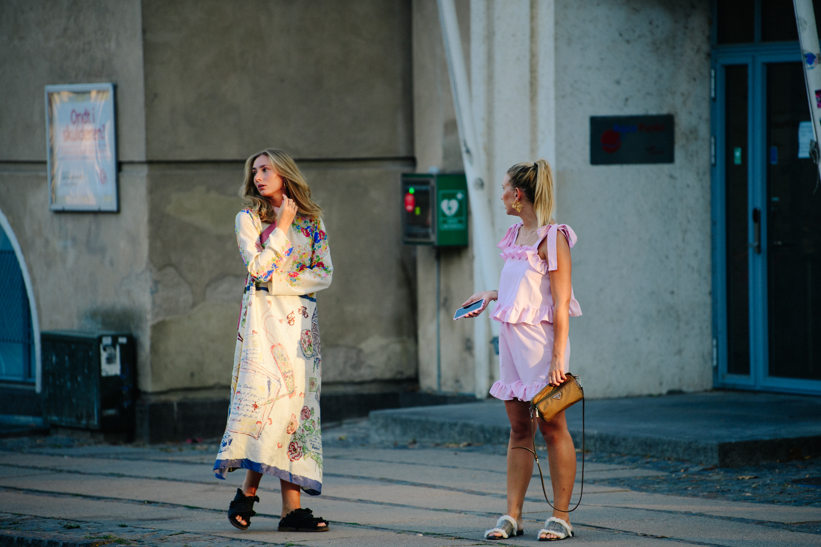 Two women wearing colourful clothing