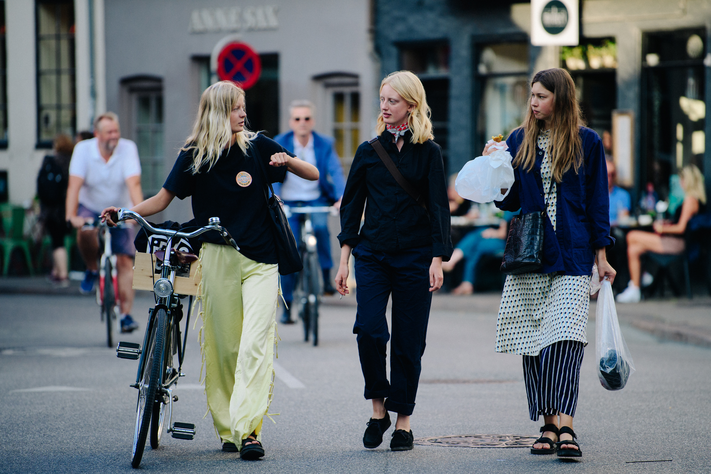 Three models wearing dark shirts