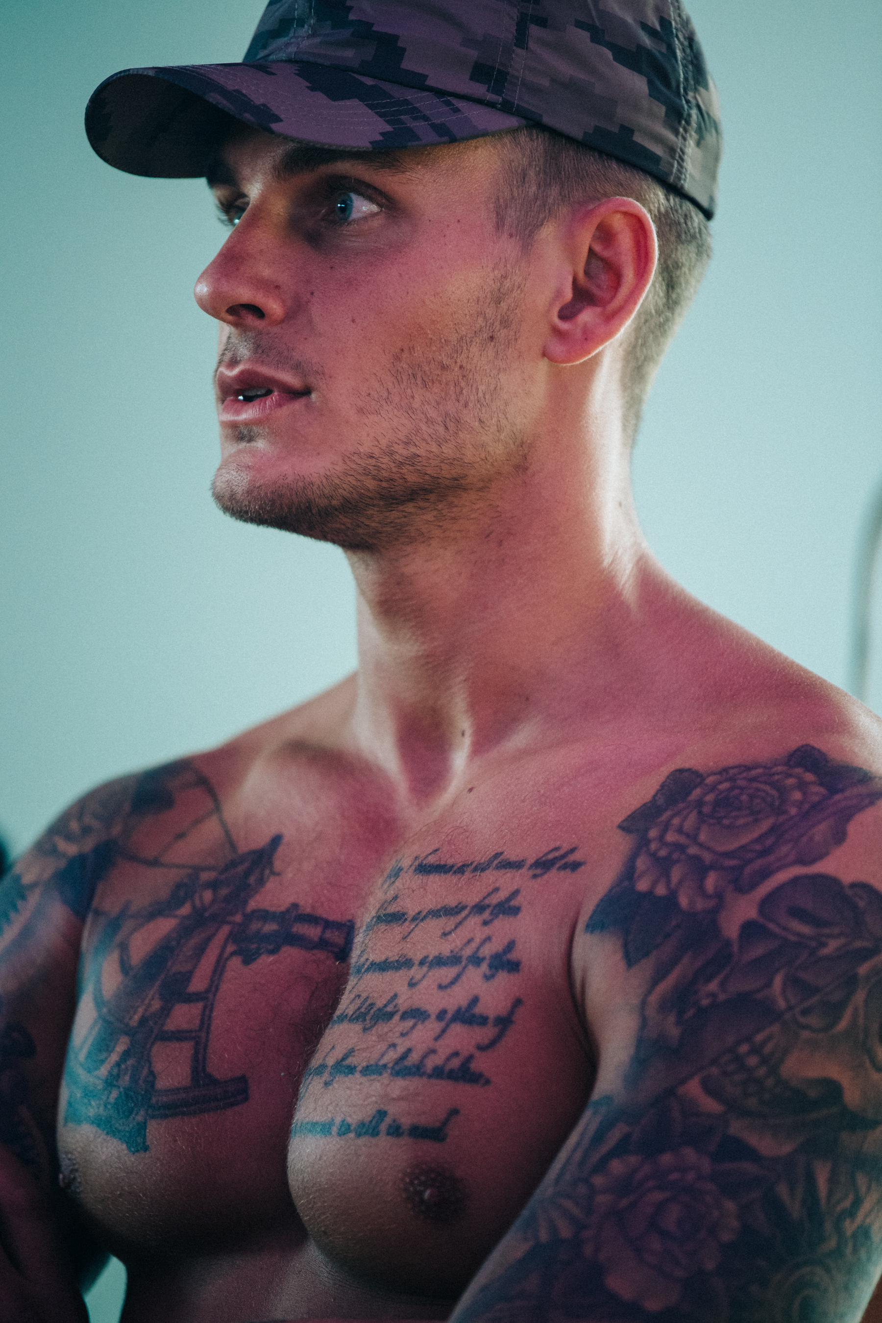 Muscular topless models backstage at HALO