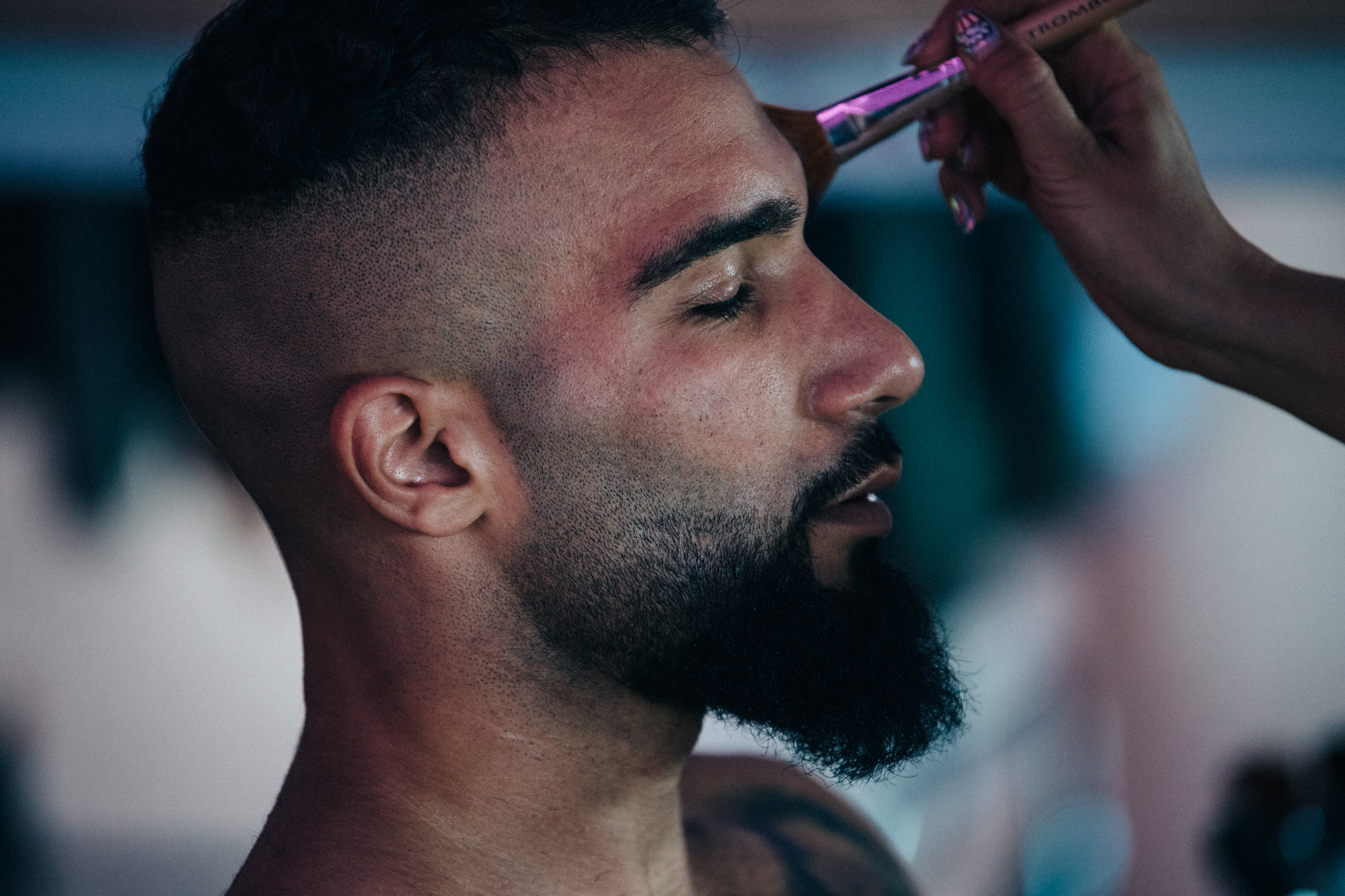 Model having makeup applied backstage