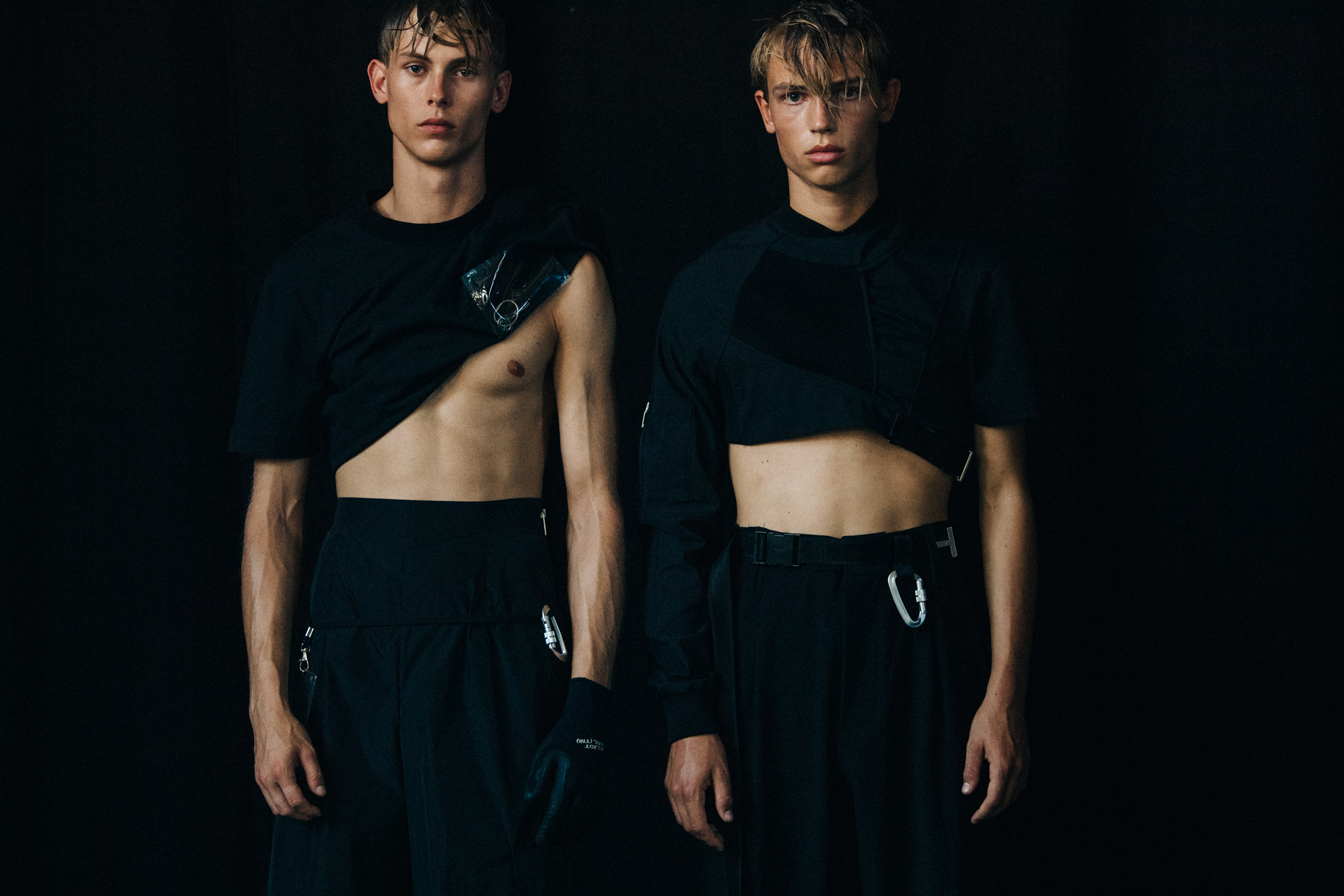 Models wearing black outfit at Heliot Emil