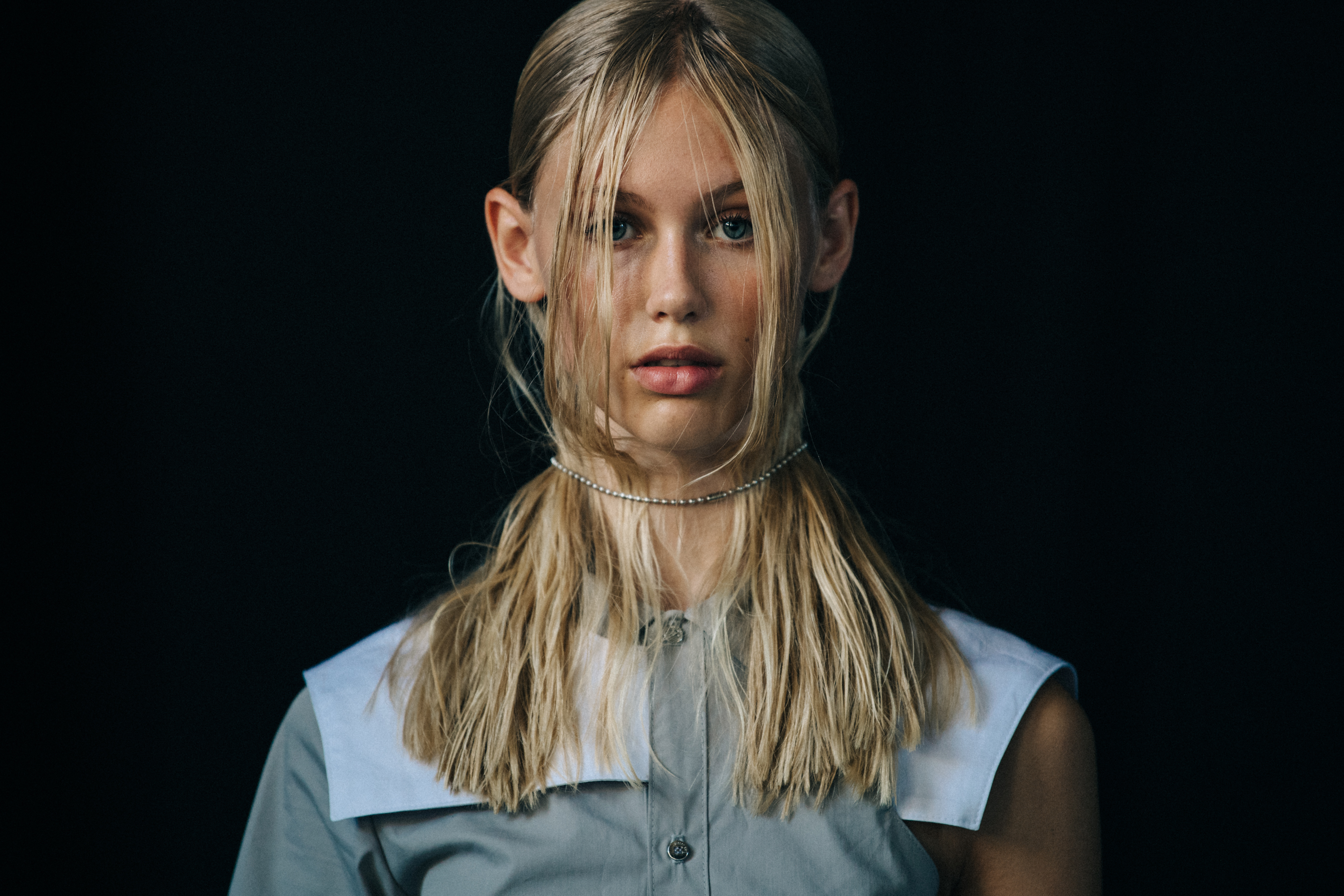 Model wearing white outfit at Heliot Emil