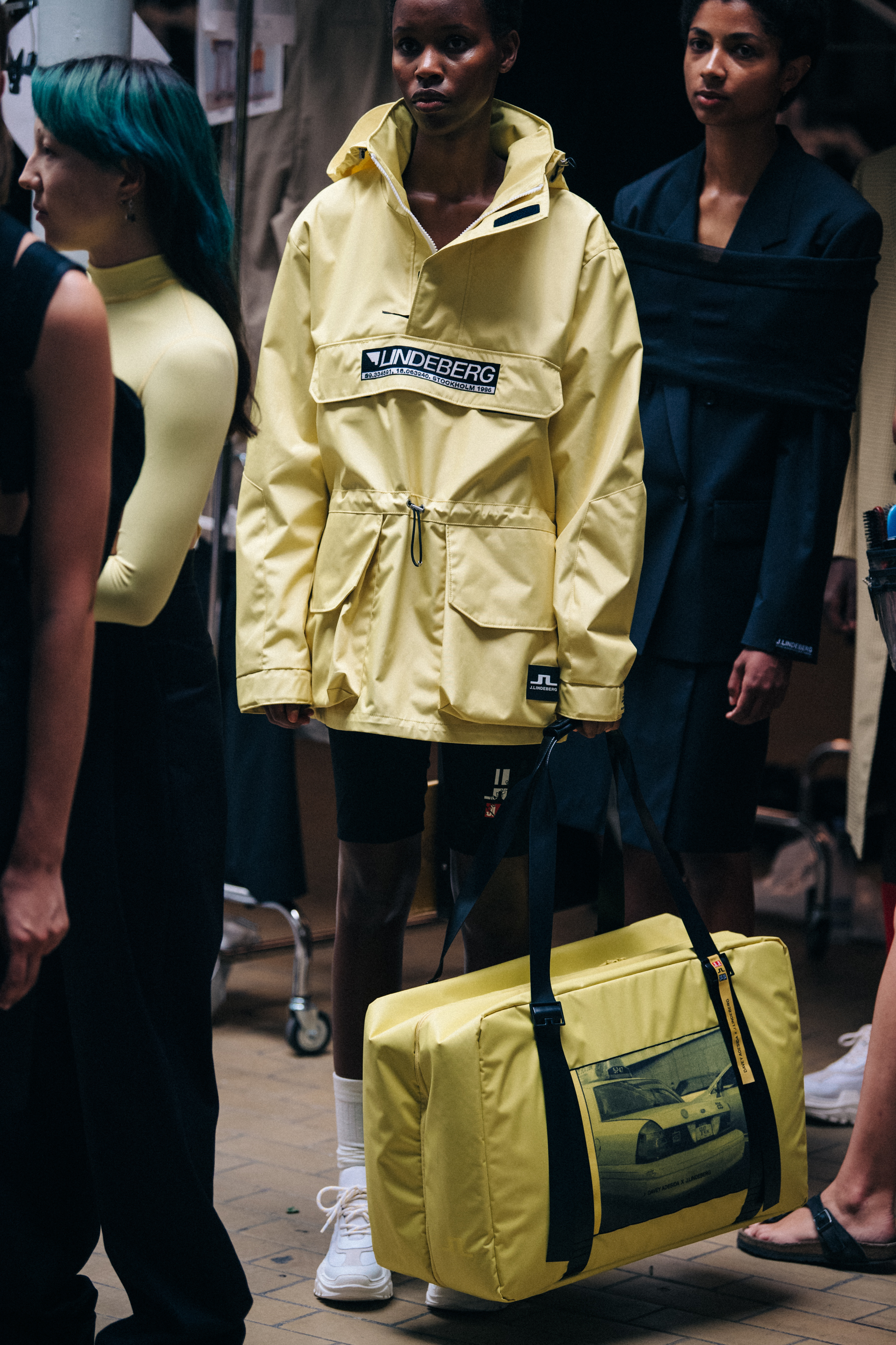 Models wearing black and yellow at J Lindeberg