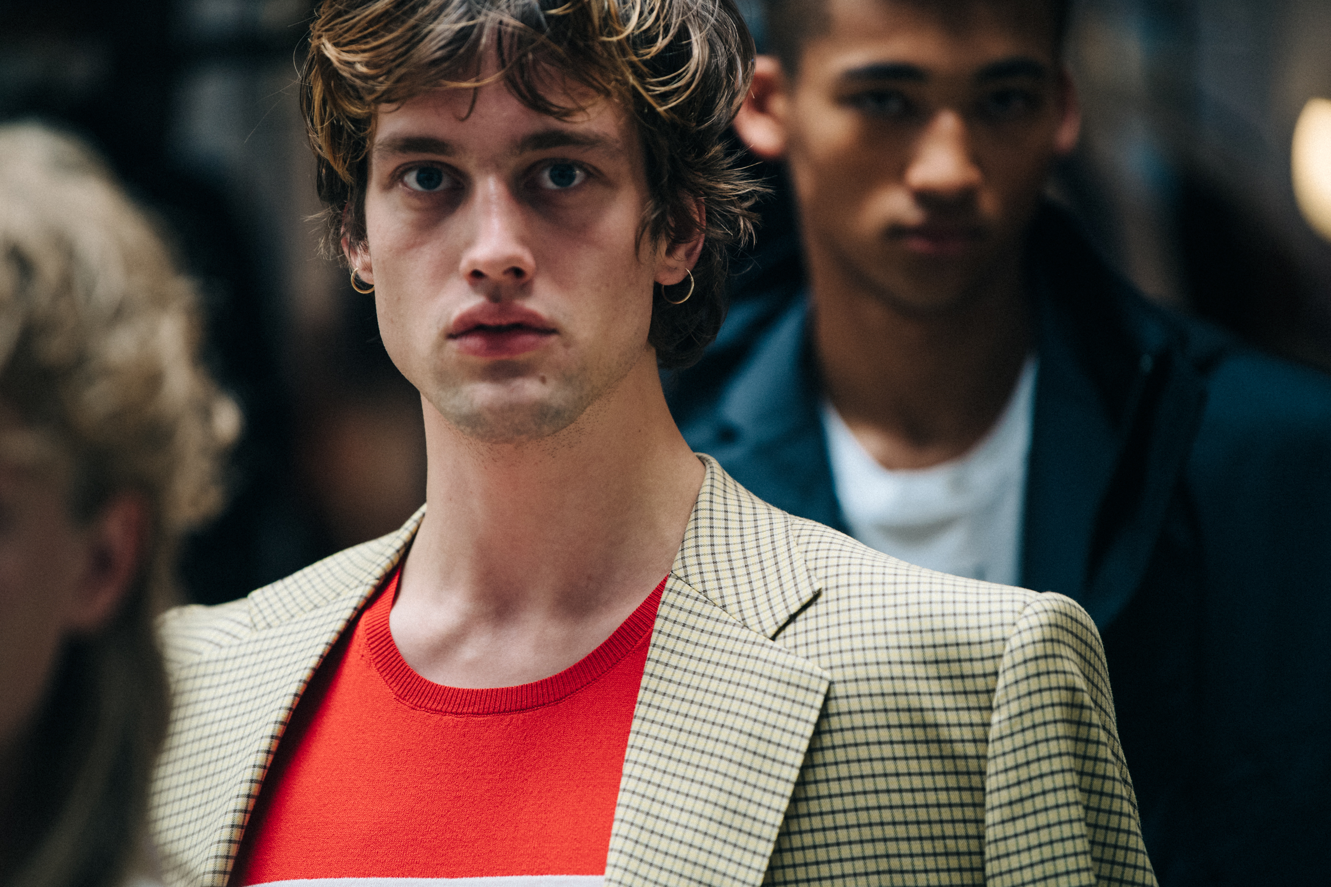 Model wearing red J Lindeberg top backstage