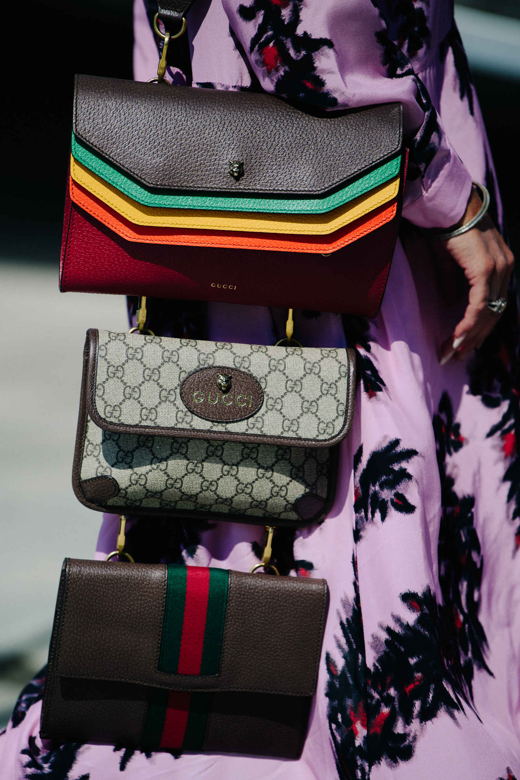 Woman carrying three Gucci bags