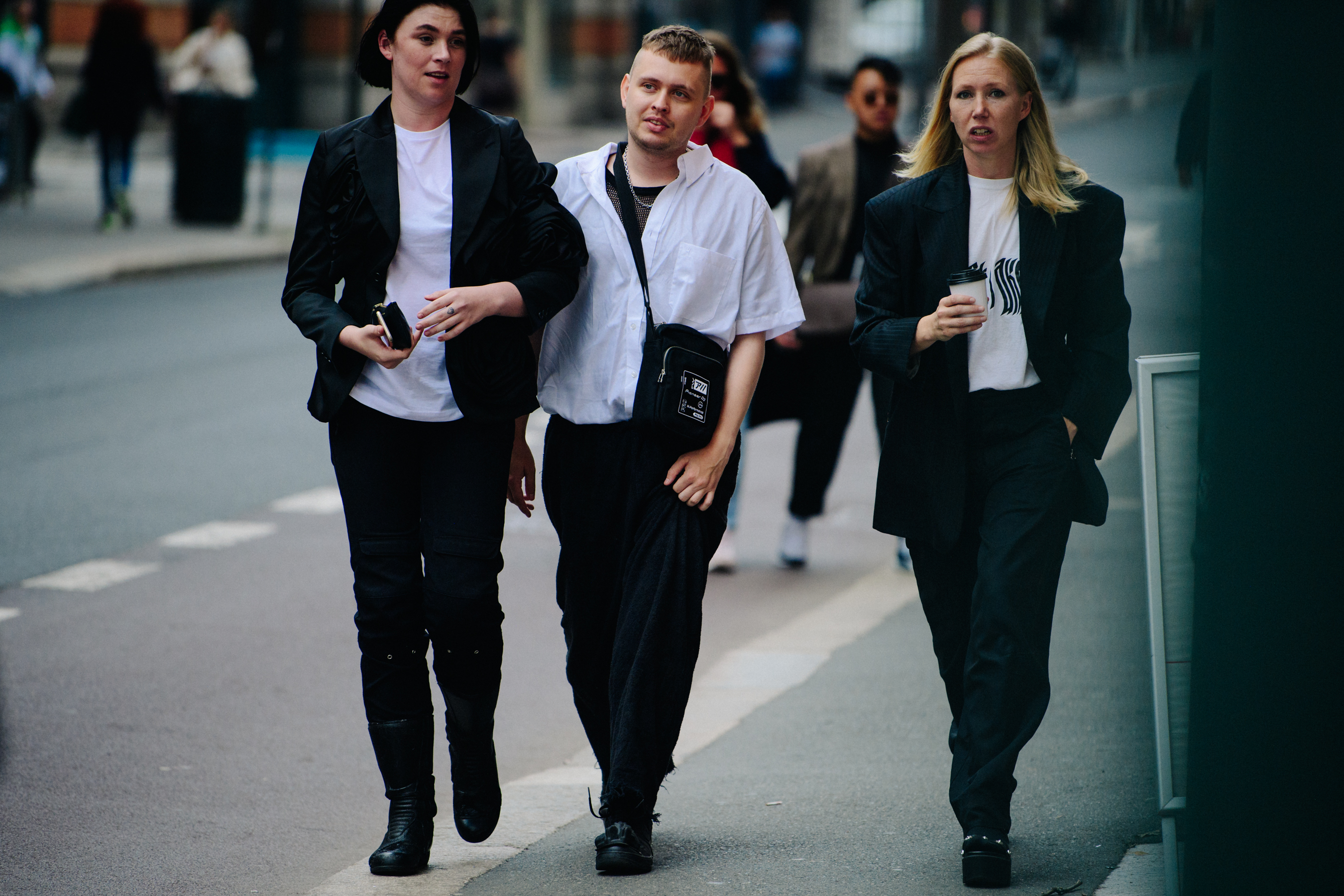 Three people wearing dark outfits