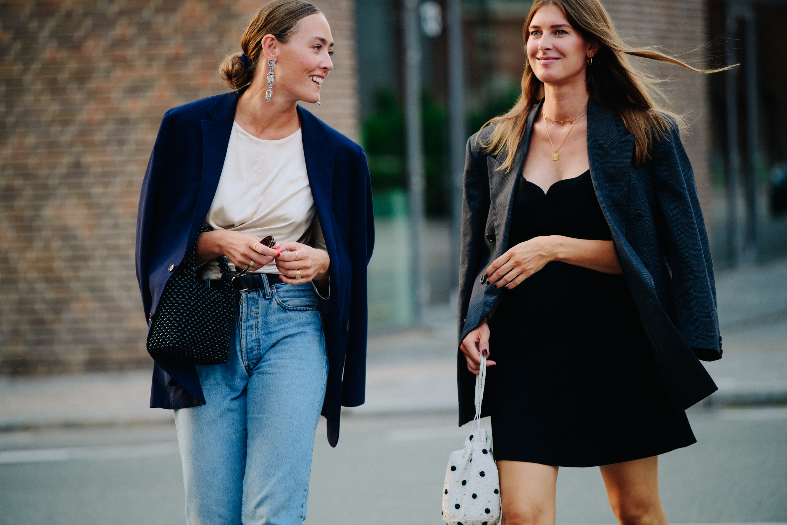 Two women wearing suit jackets