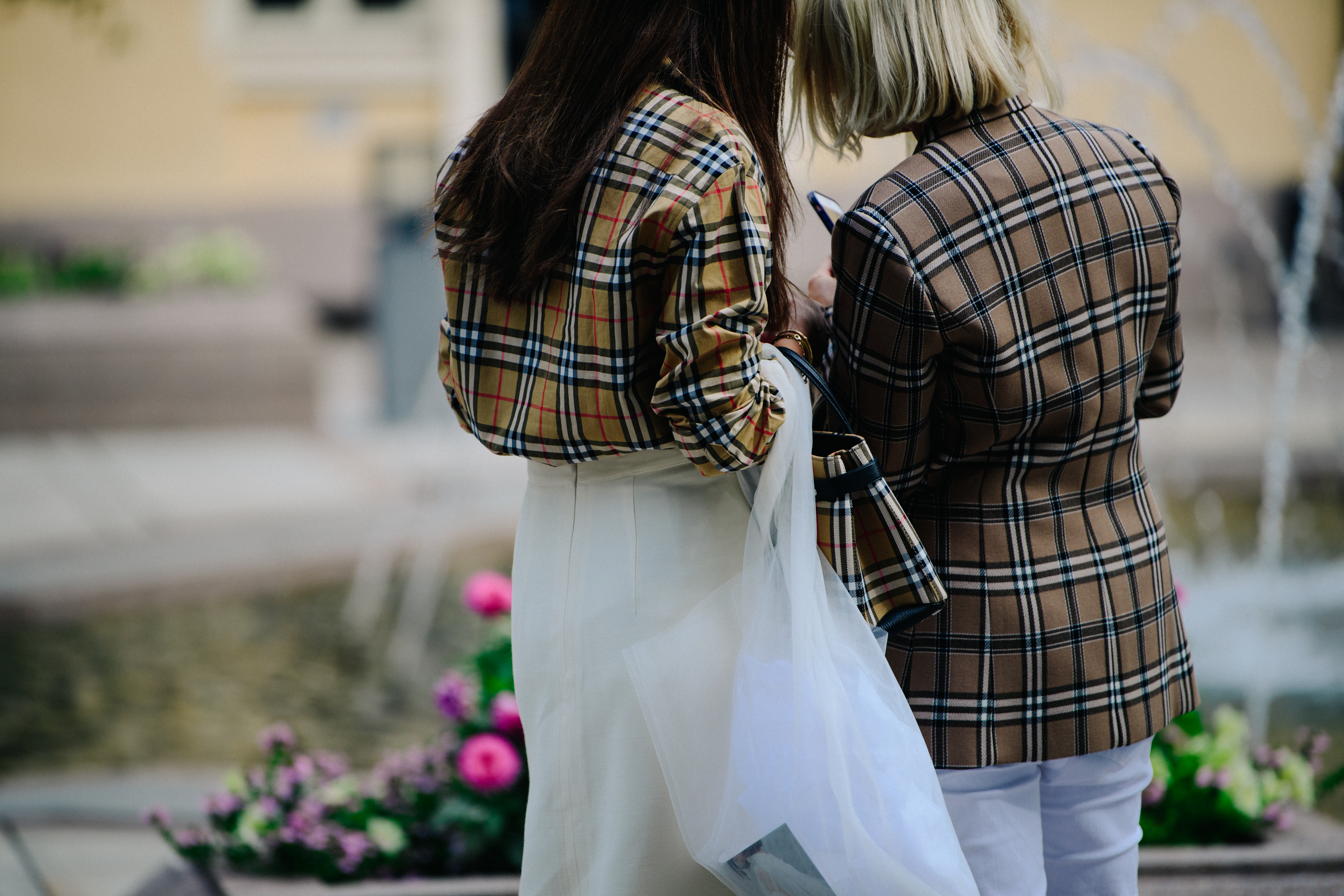 Two women wearing Burberry shirts