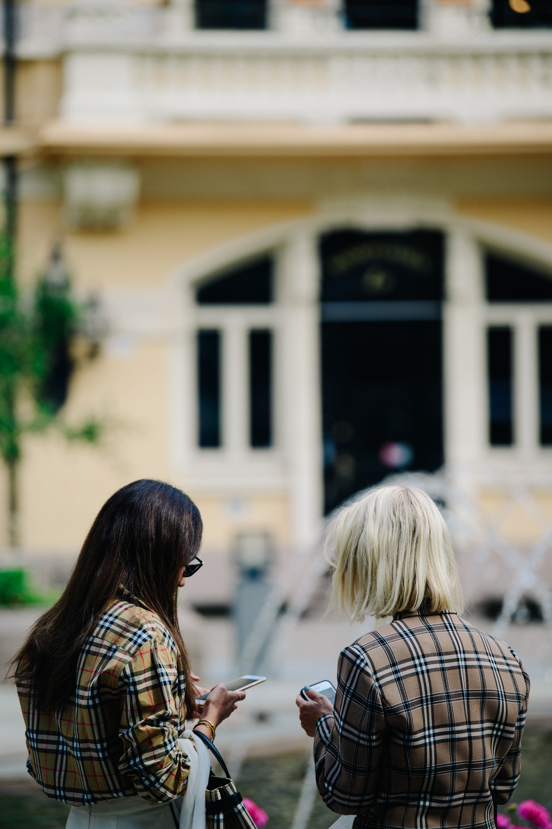 Two women wearing Burberry shirts