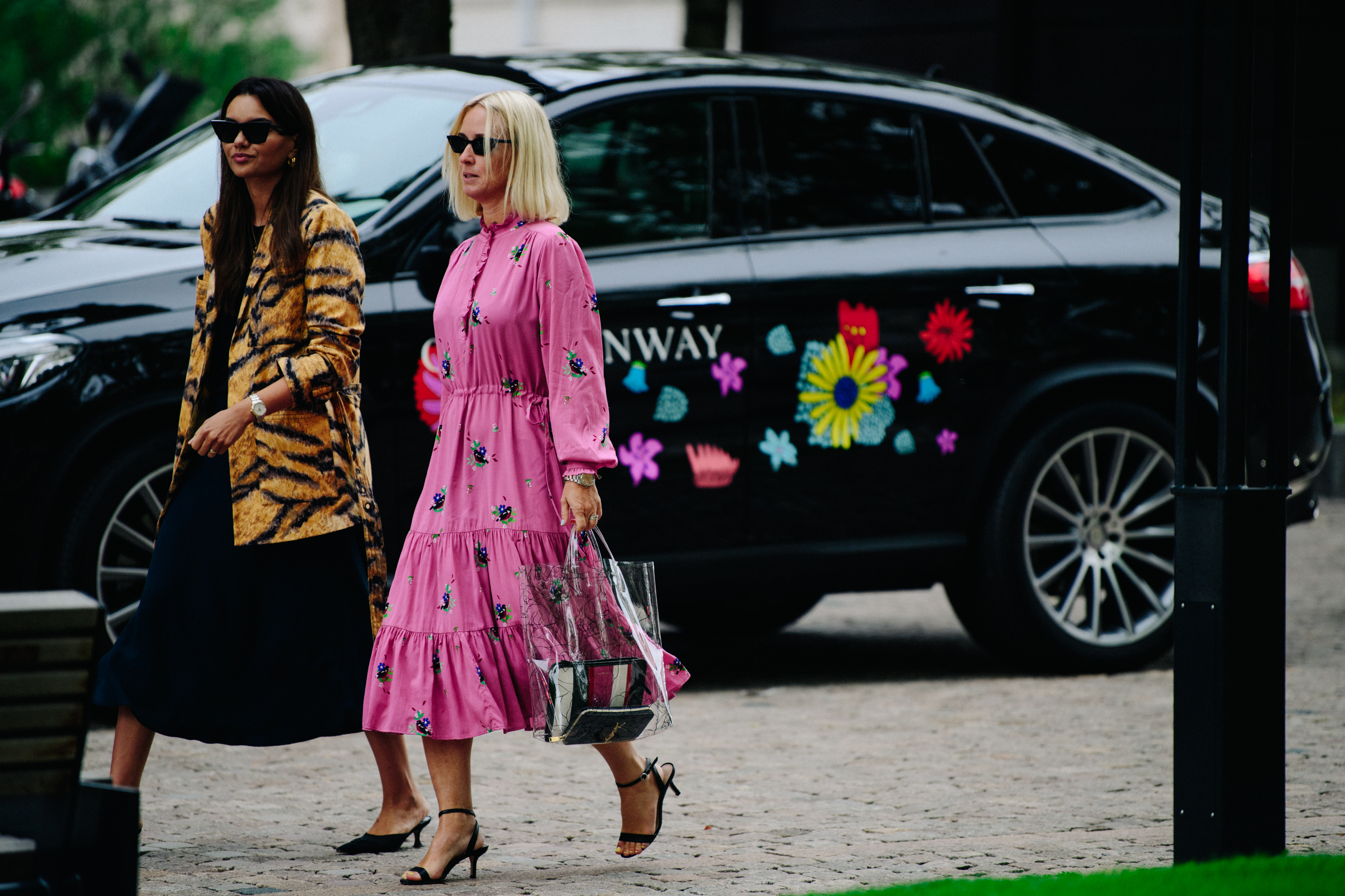 Two women wearing colourful outfits