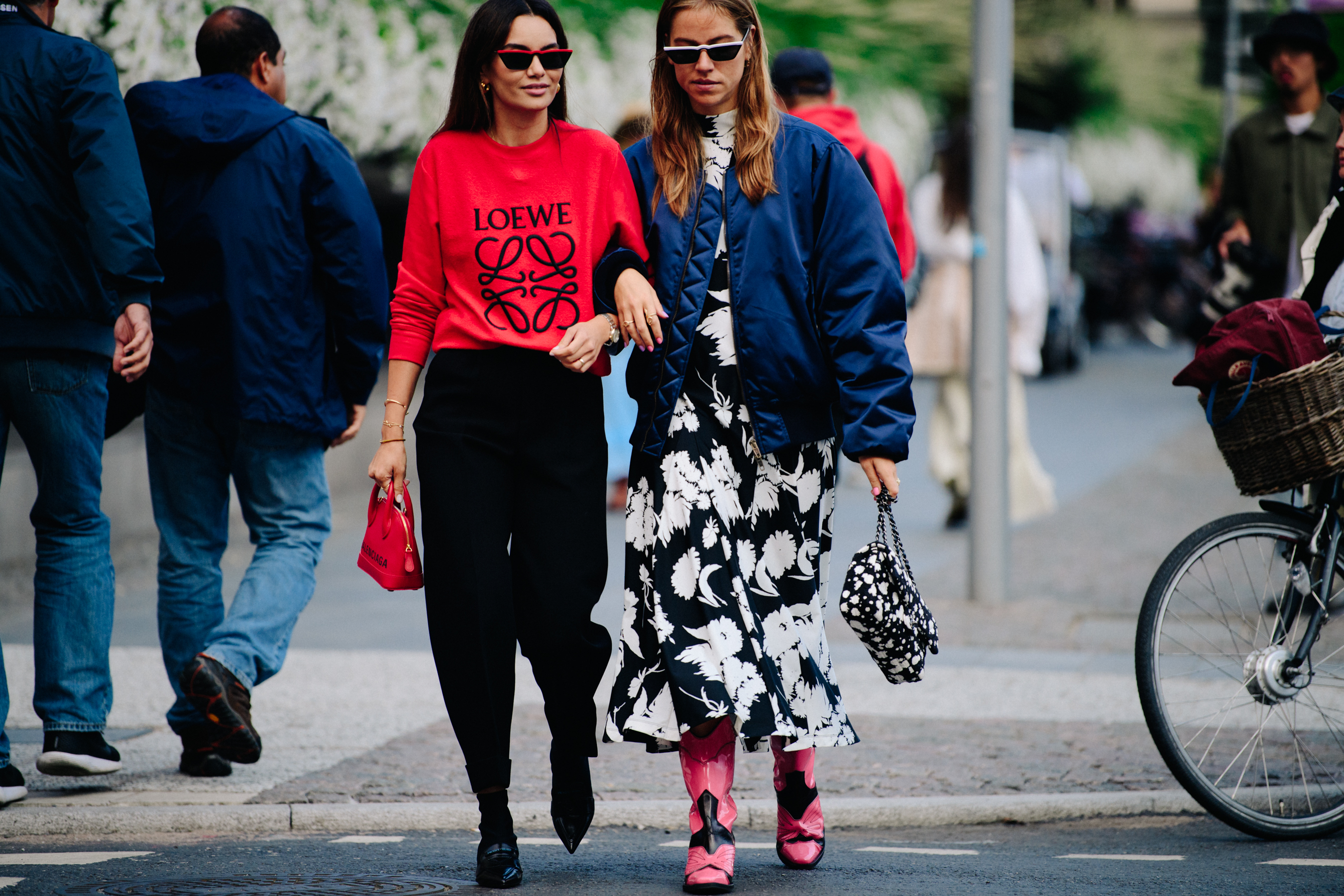 Two women wearing blue and red