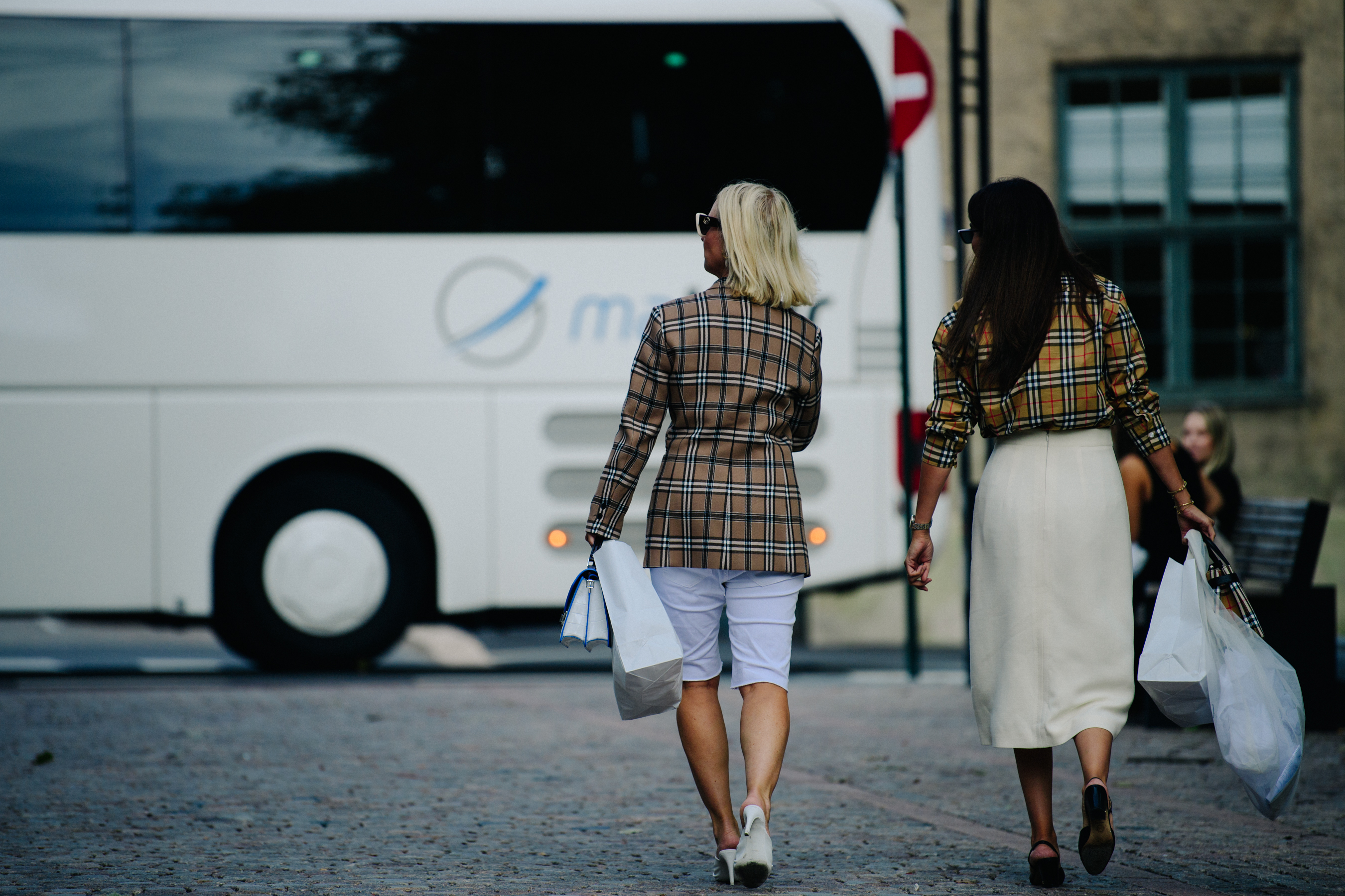 Two women wearing Burberry shirts