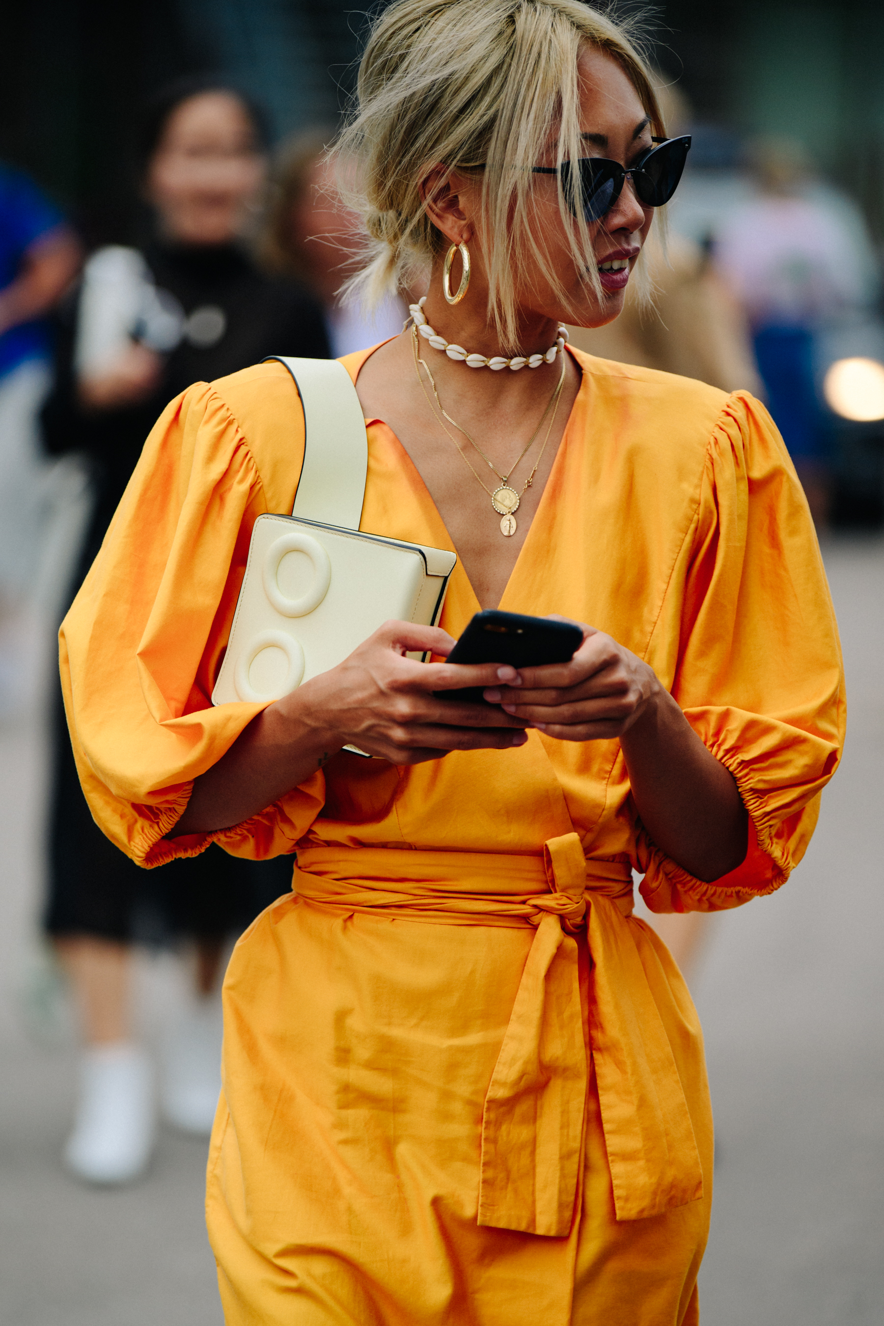 Asian blogger wearing orange outfit