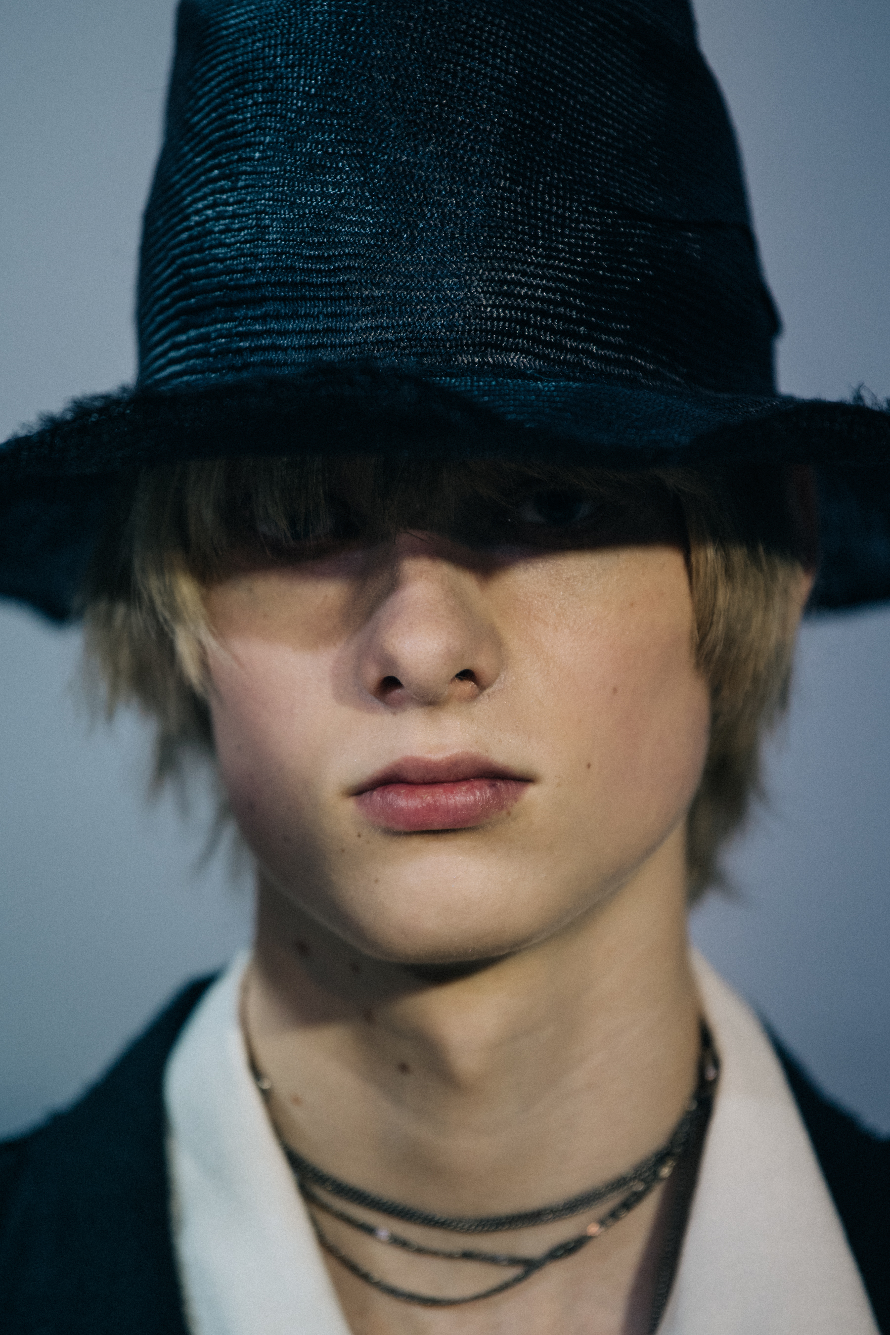 Portrait of model wearing black rimmed hat