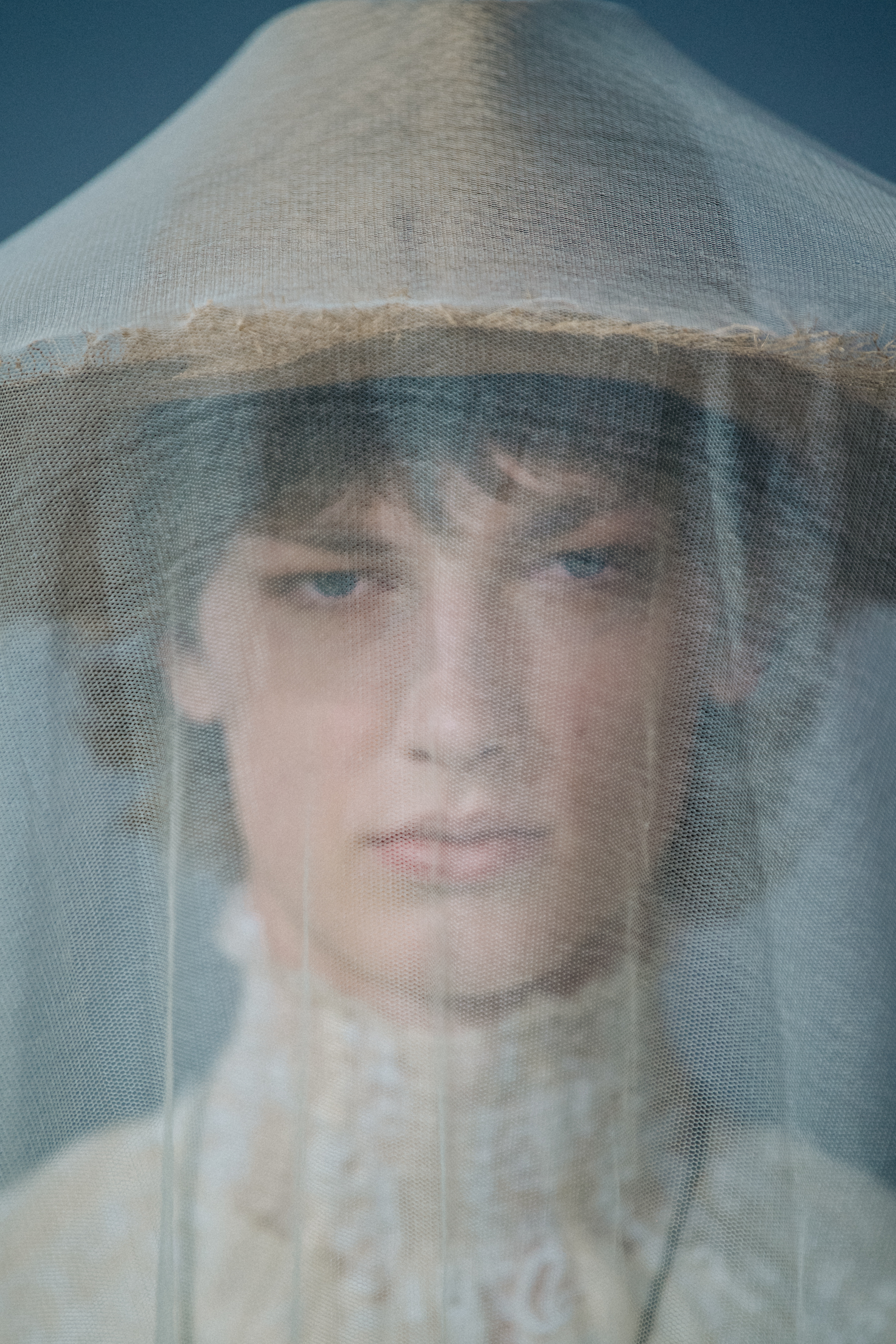 Portrait of model wearing white veil and hat