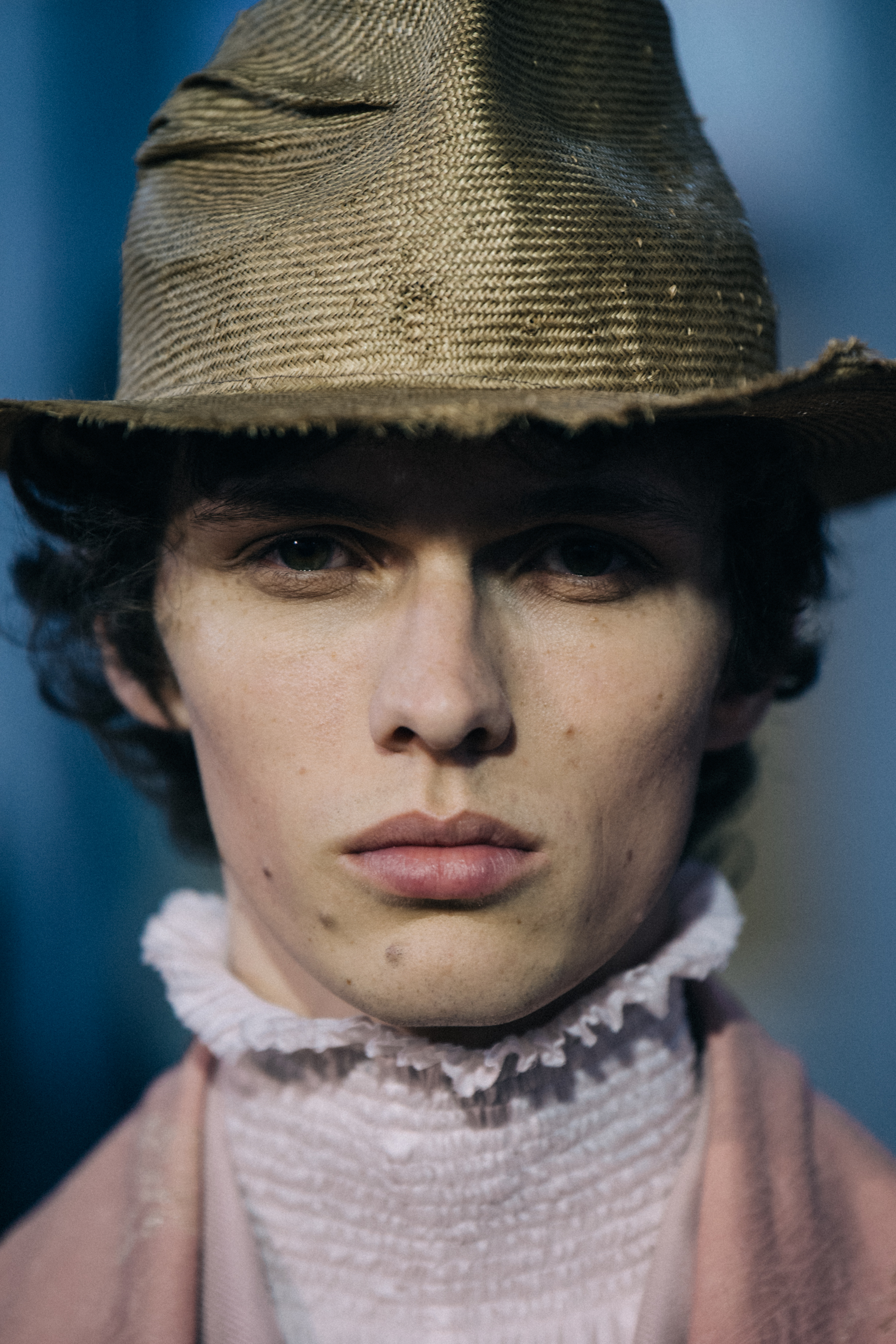 Portrait of model wearing straw rimmed hat