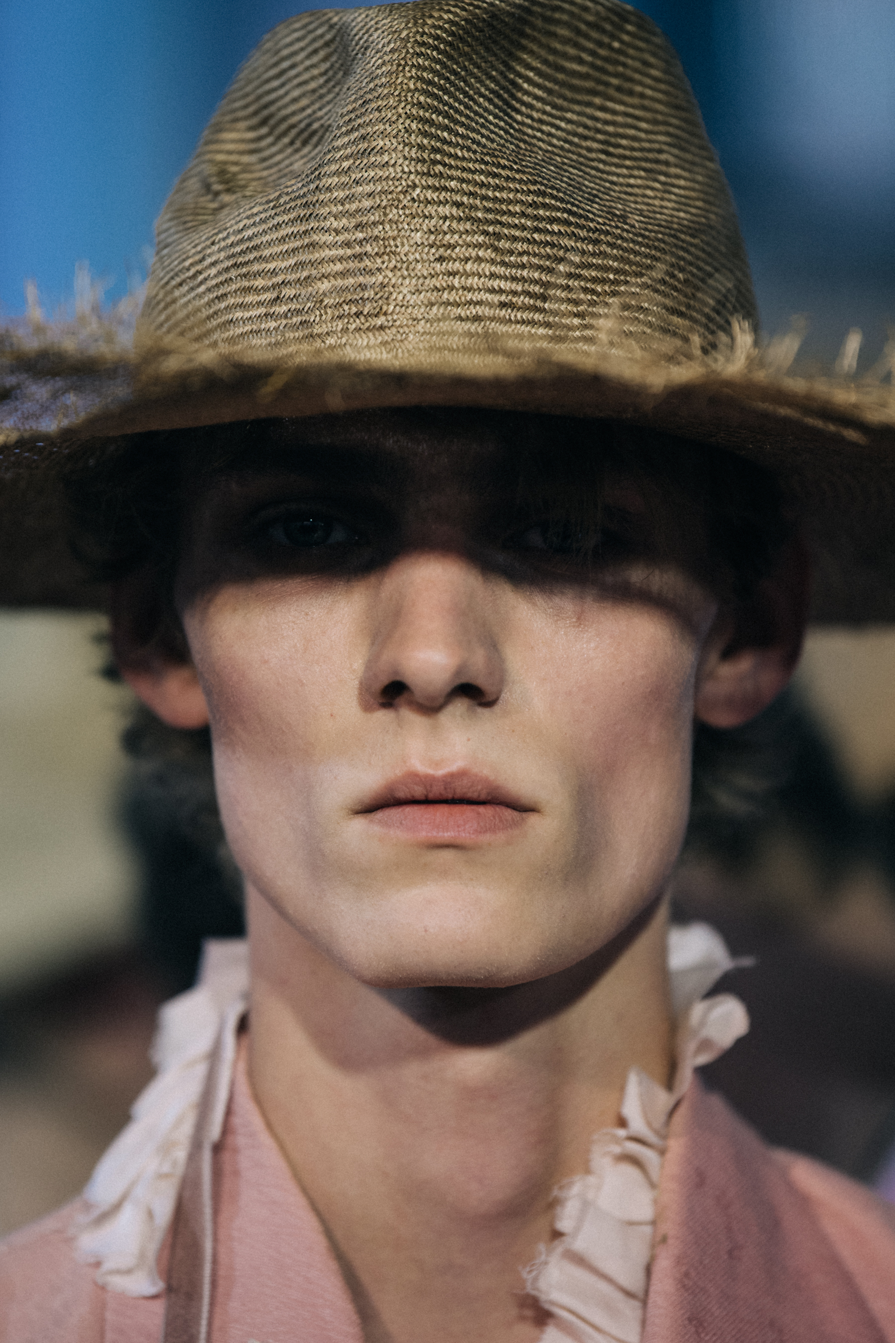 Portrait of model wearing straw rimmed hat