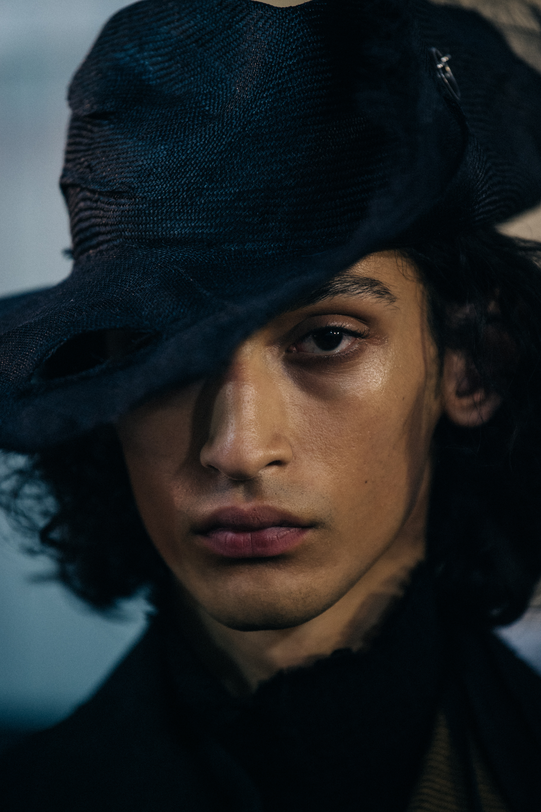 Portrait of model wearing black rimmed hat