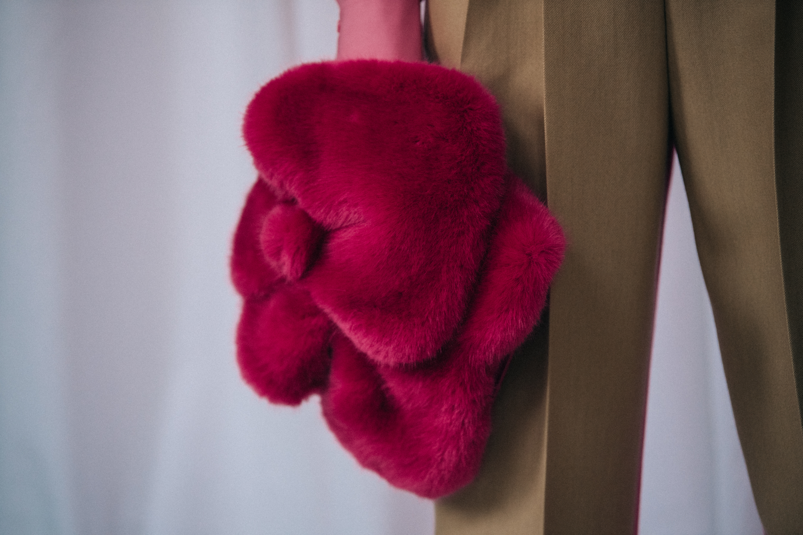 Model holding furry accessory at Delpozo