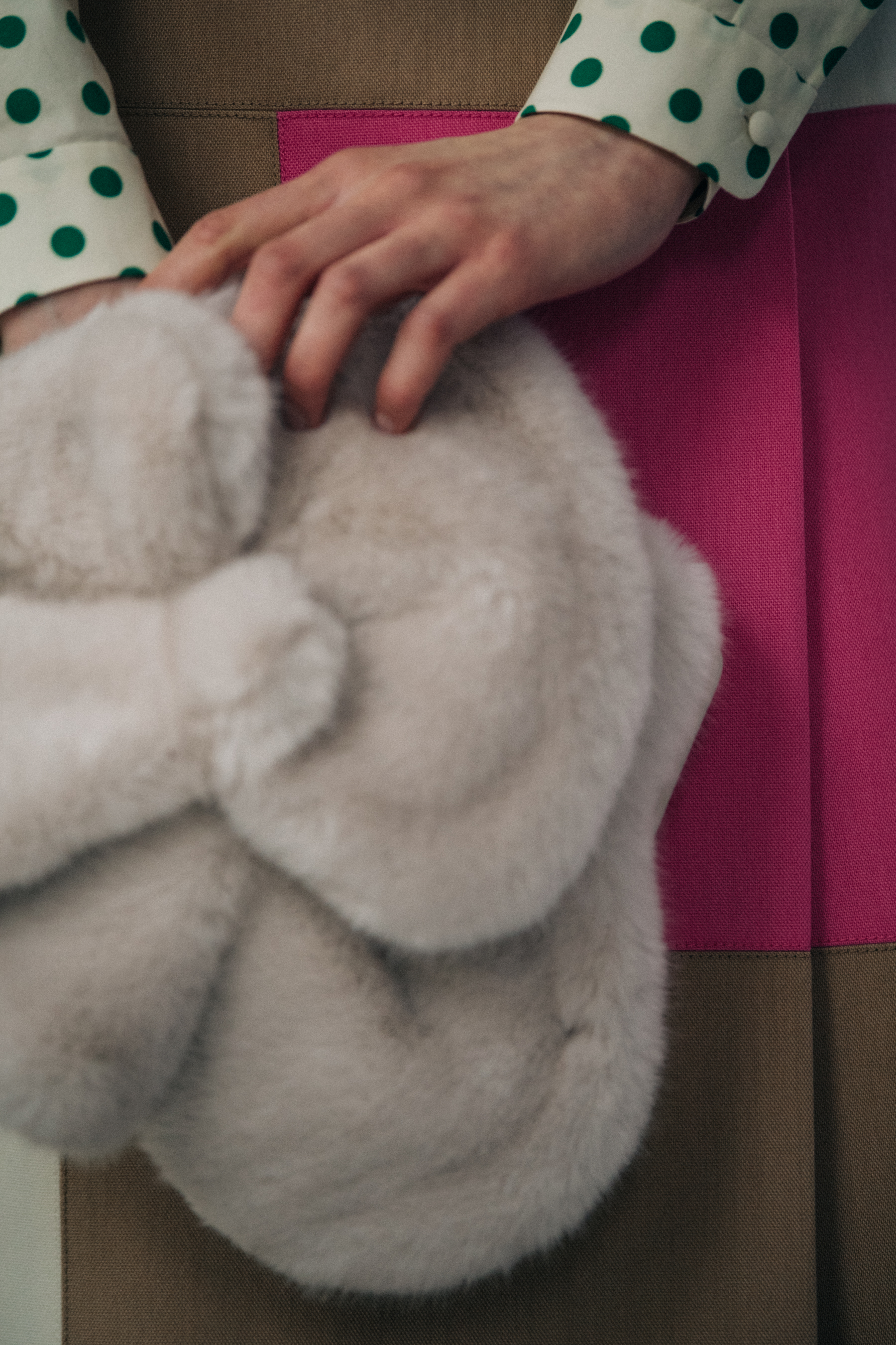 Model holding furry accessory at Delpozo