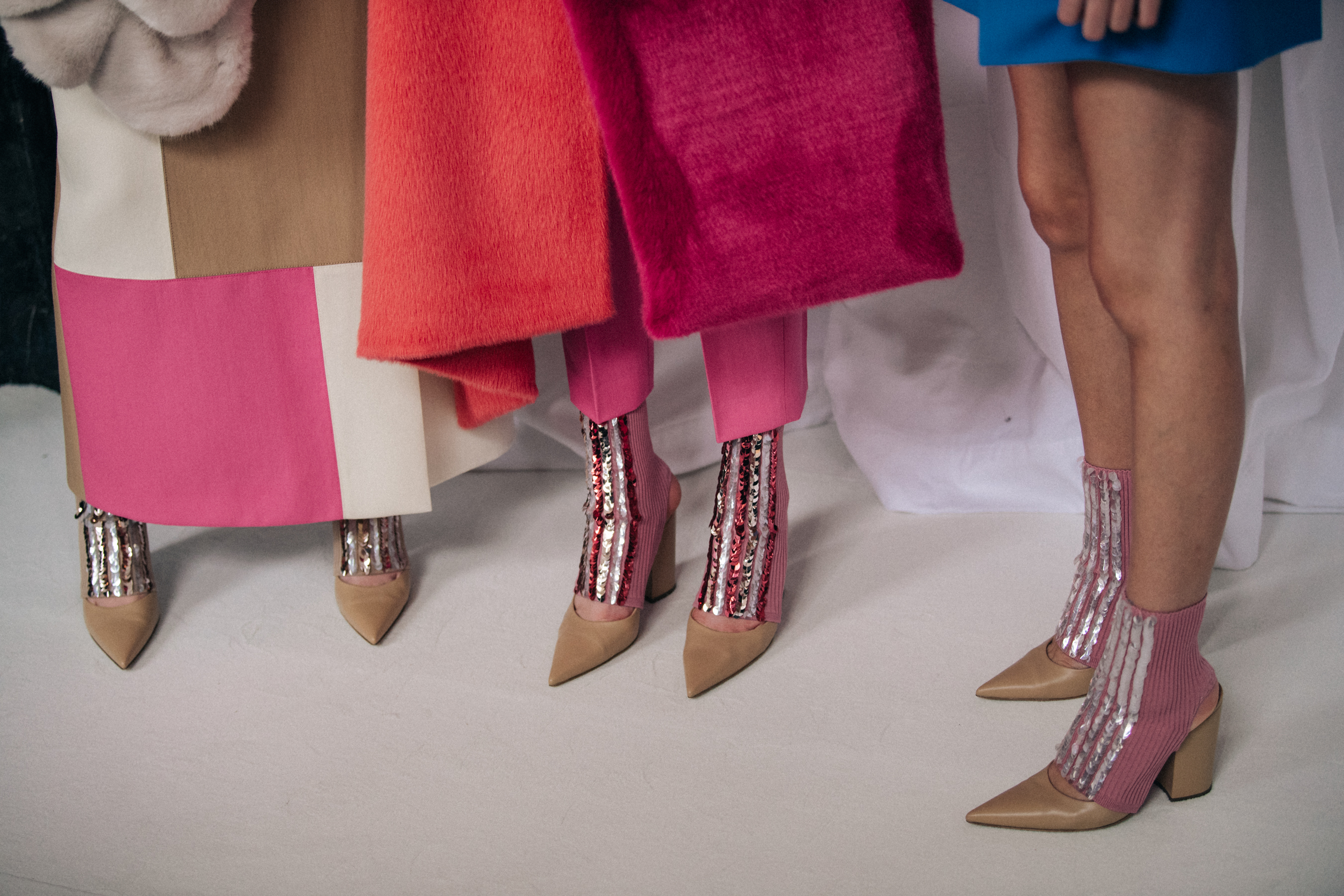 Models wearing shiny pink heels