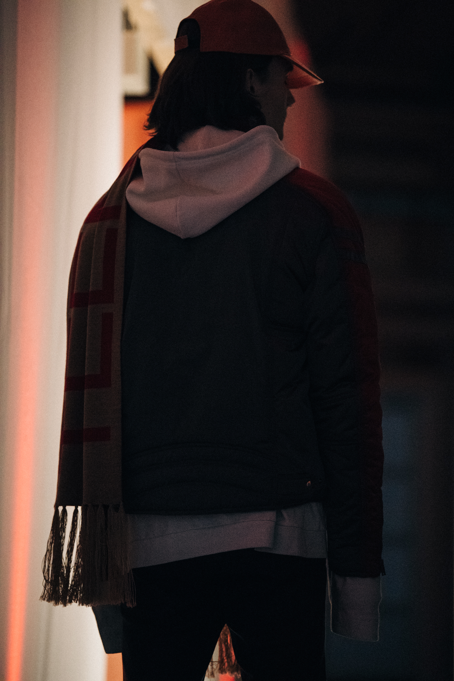 Model wearing red and white backstage at Martin Asbjorn