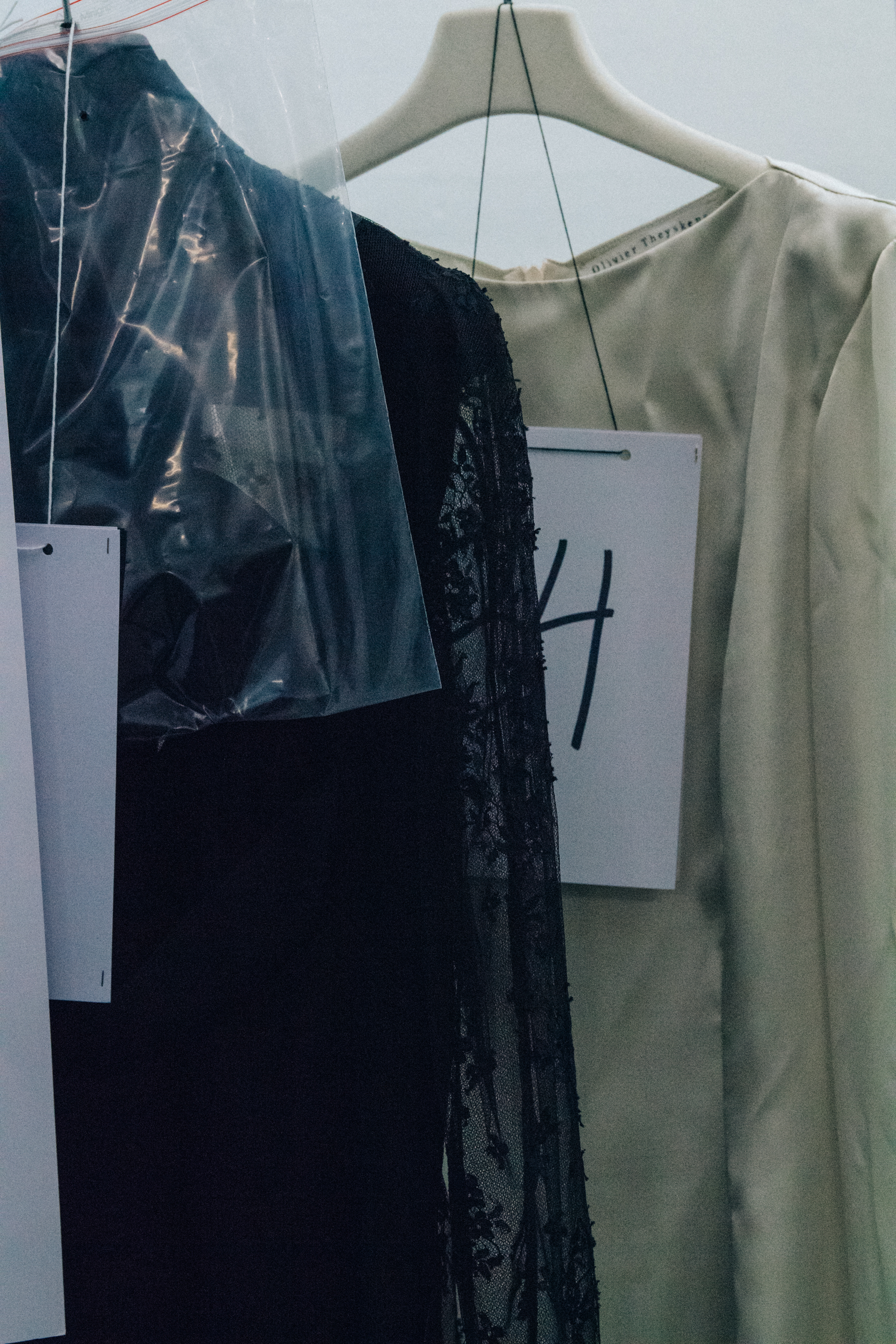 Outfits hanging backstage at Olivier Theyskens