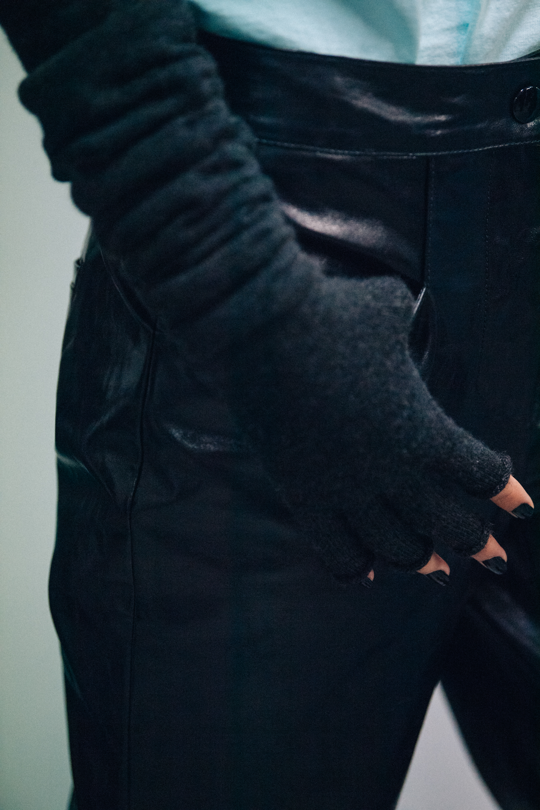 Model wearing black leather backstage