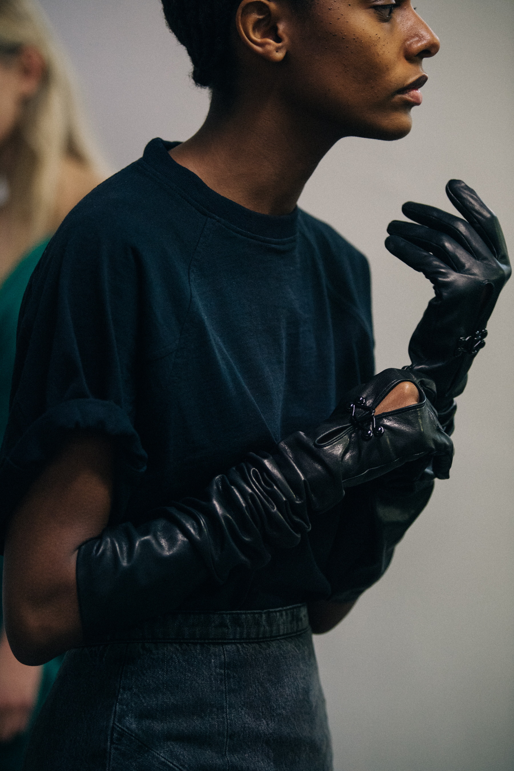 Model wearing black leather backstage