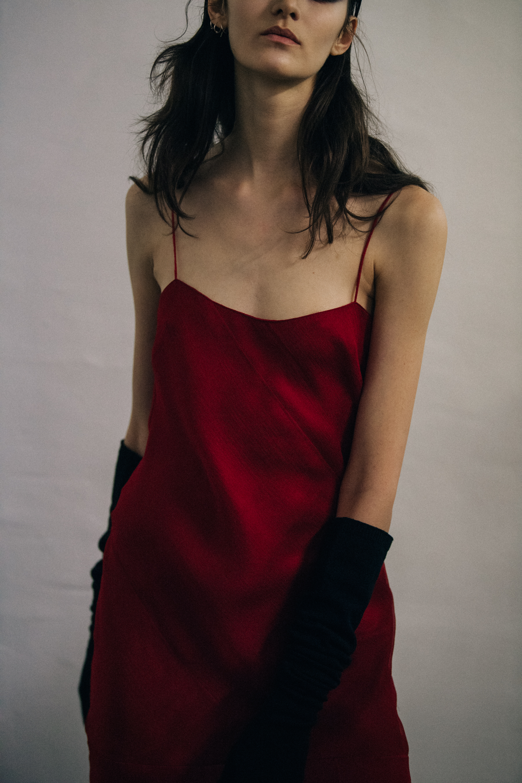 Model wearing red dress backstage
