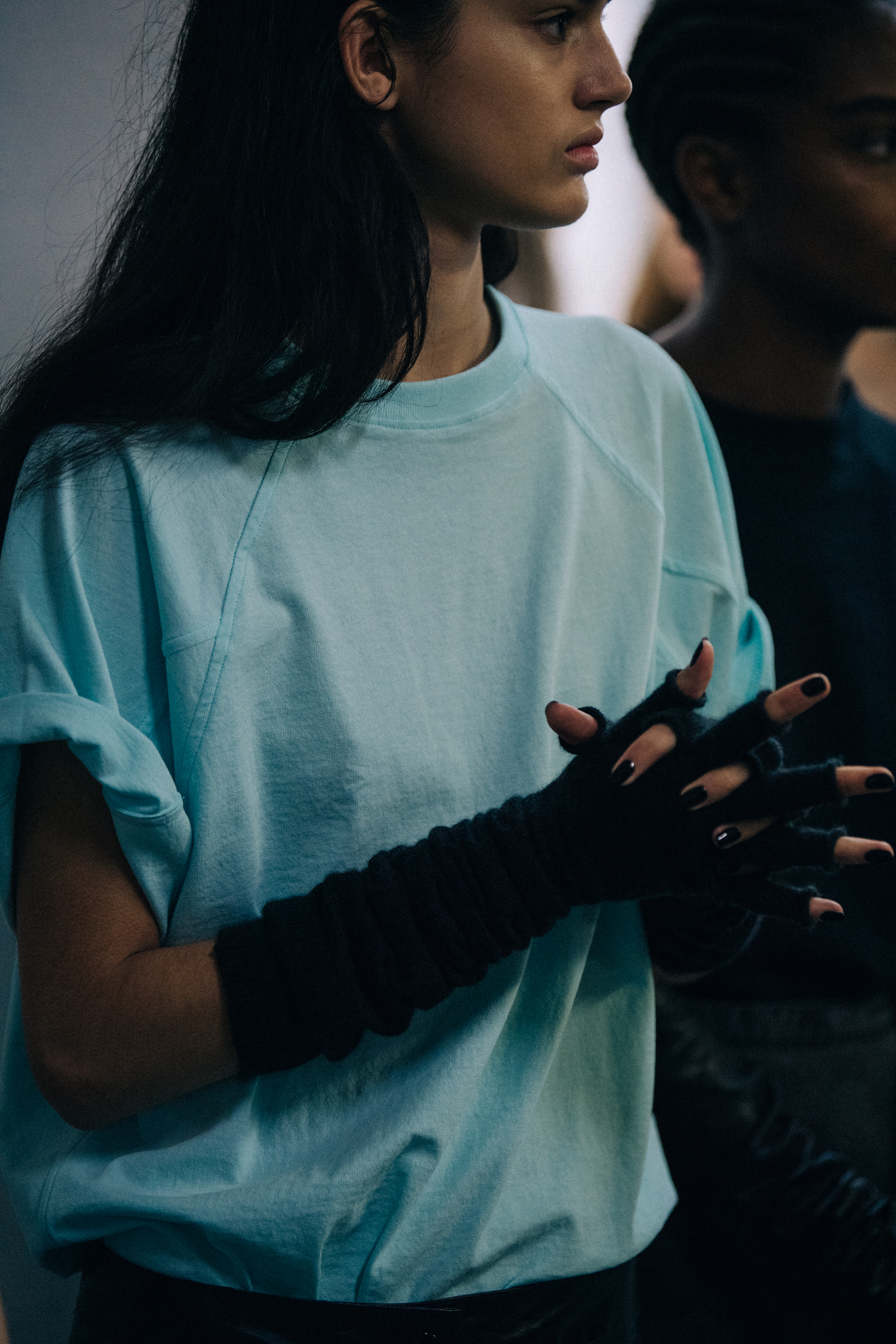 Model wearing blue tee shirt backstage