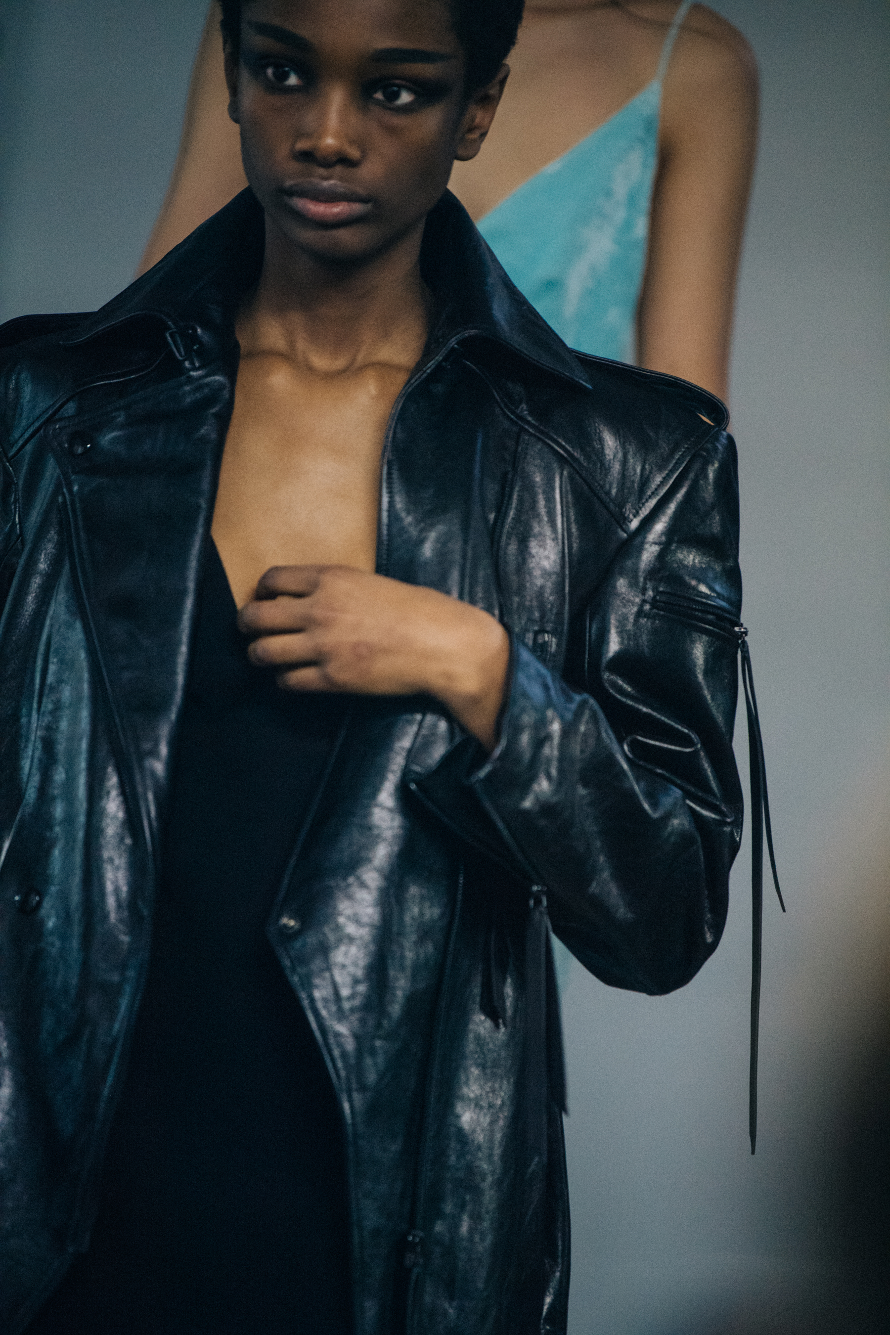 Model wearing black leather backstage
