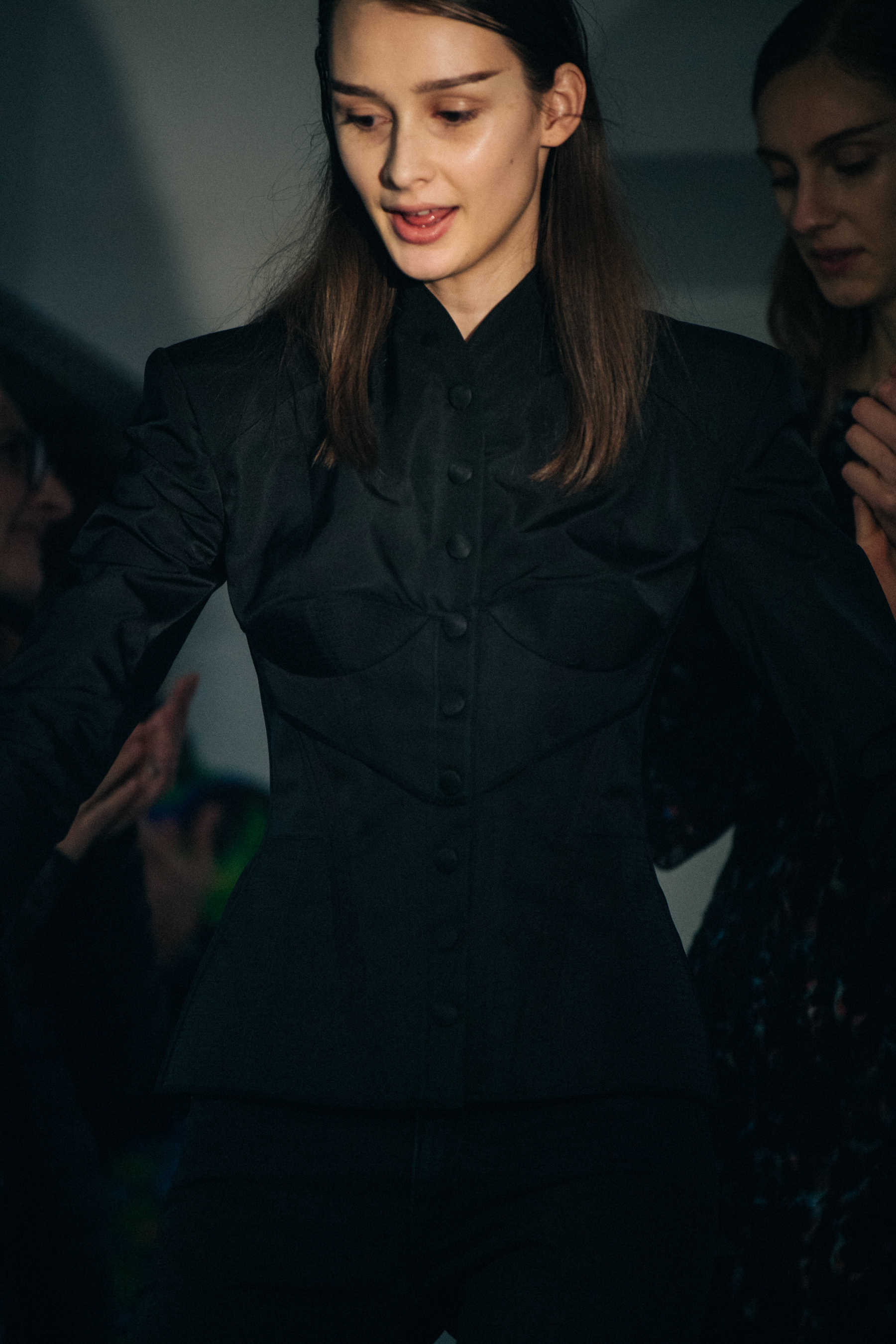 Model wearing black shirt backstage at Olivier Theyskens