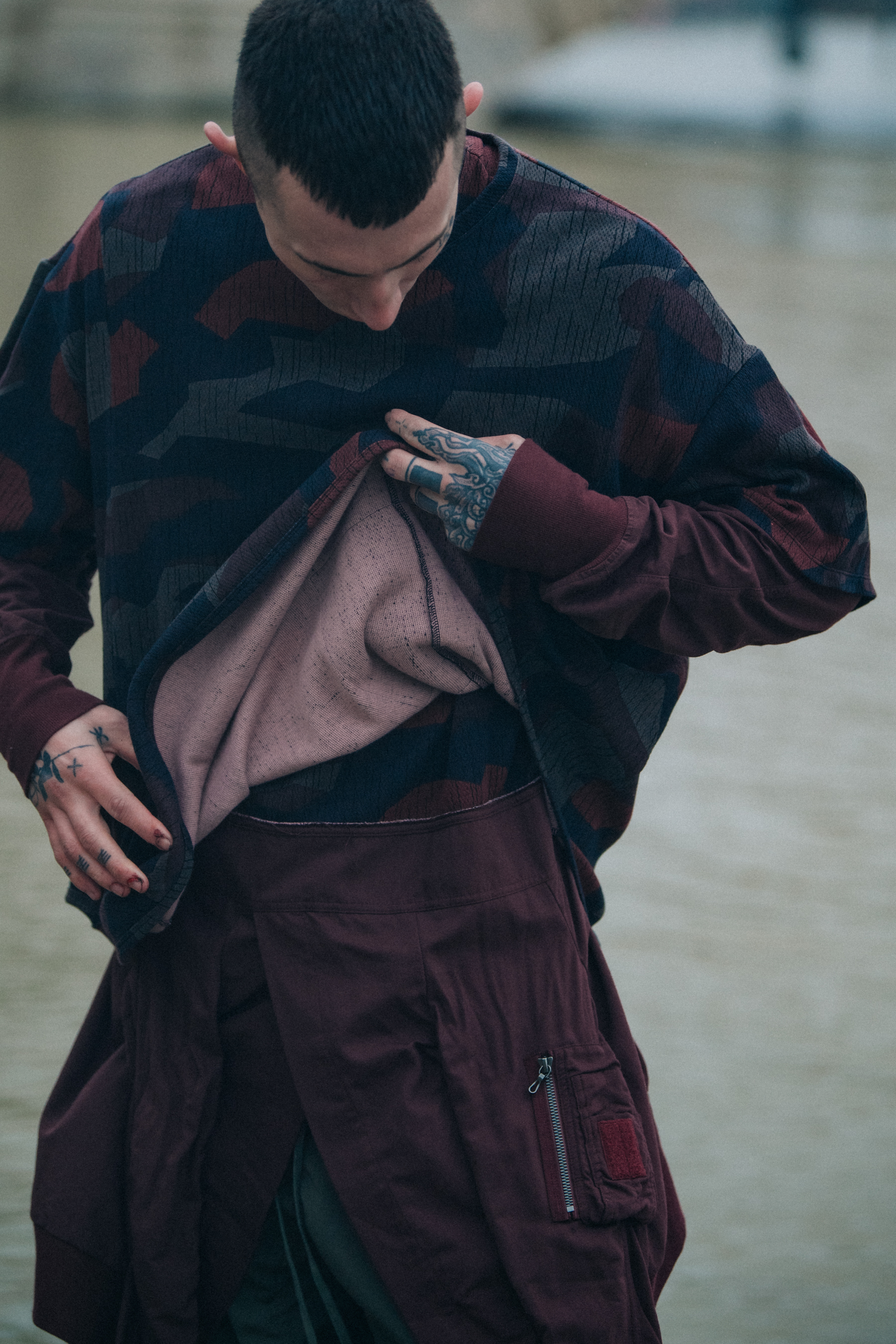 Model wearing baggy red and black outfit